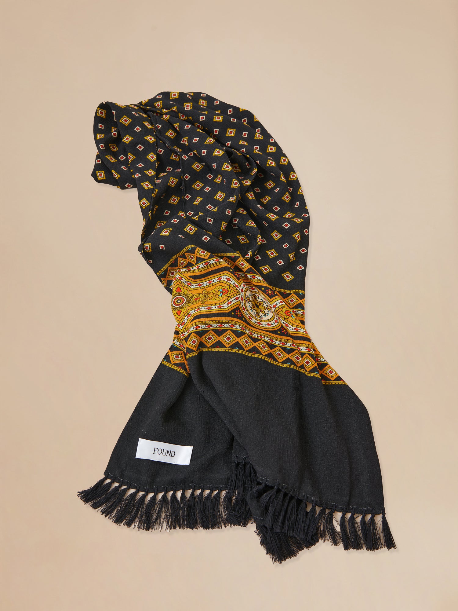 A black and yellow Found Pastures Print Scarf with hand-tied tassels.