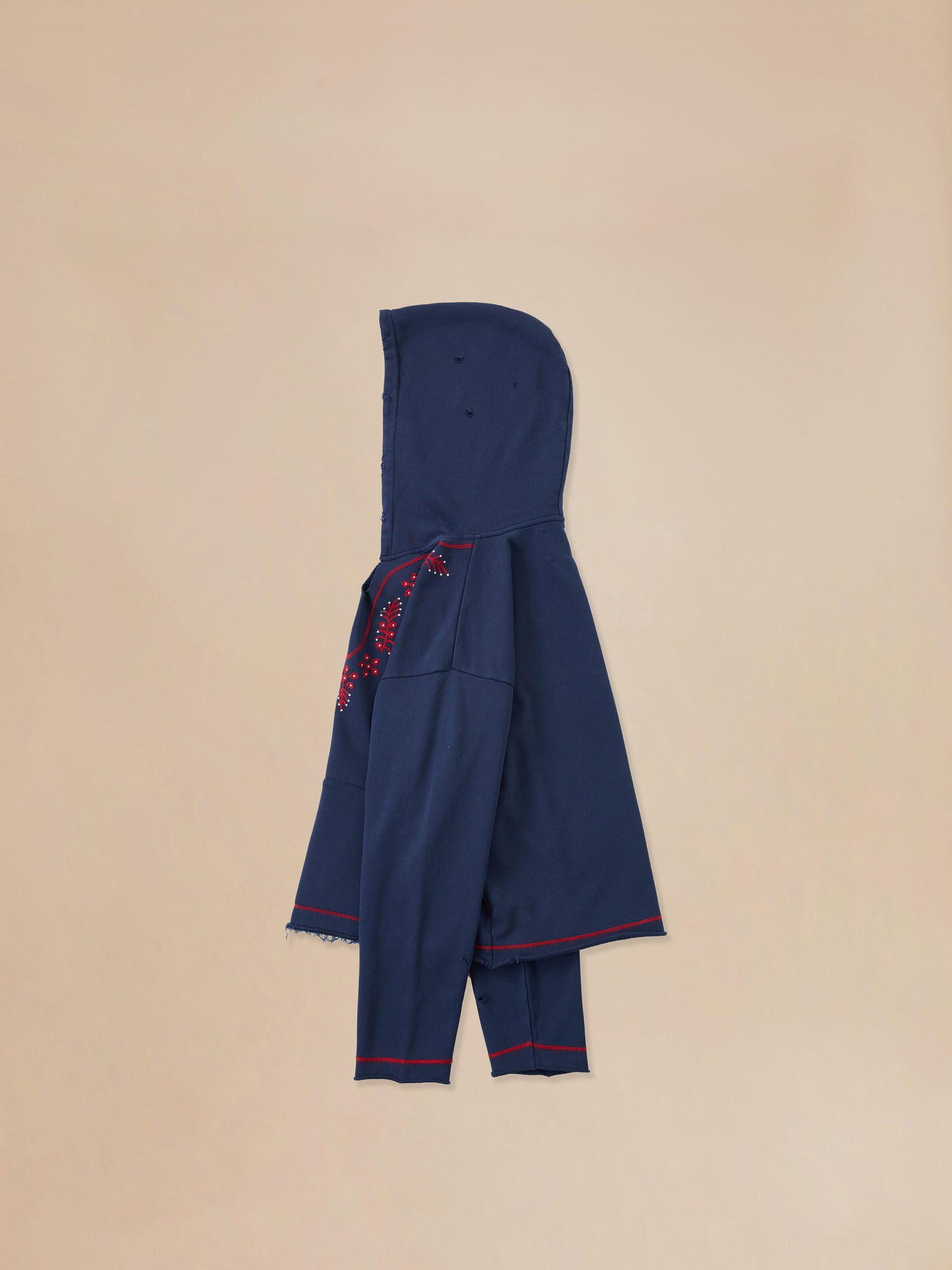A child's Indus Embroidered Hoodie in navy with red trim by Found.