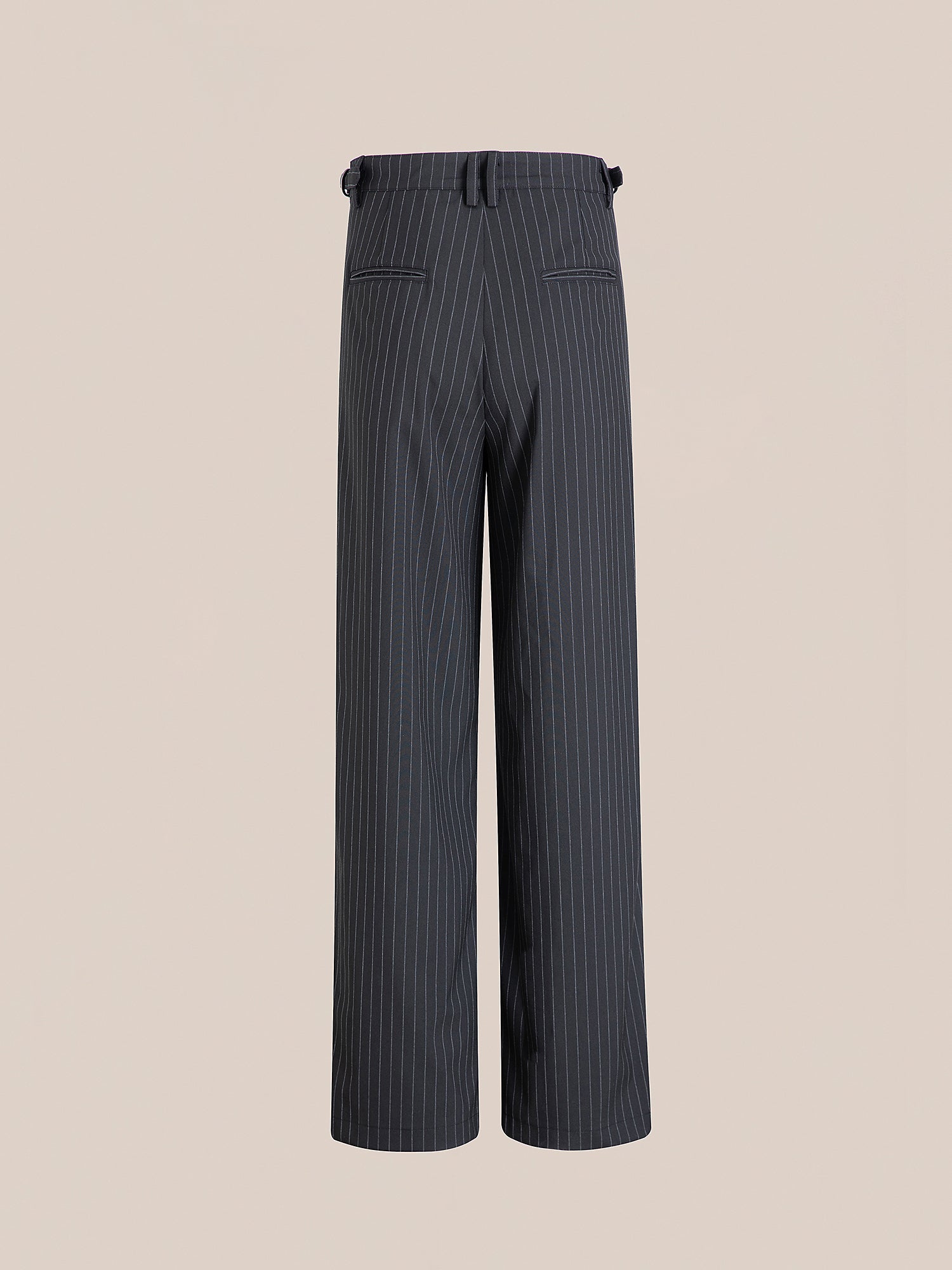 The Pinstripe Pleated Trousers by FOUND are depicted from the back against a plain background, showcasing their high-rise, wide-leg design in gray with adjustable waist tabs.