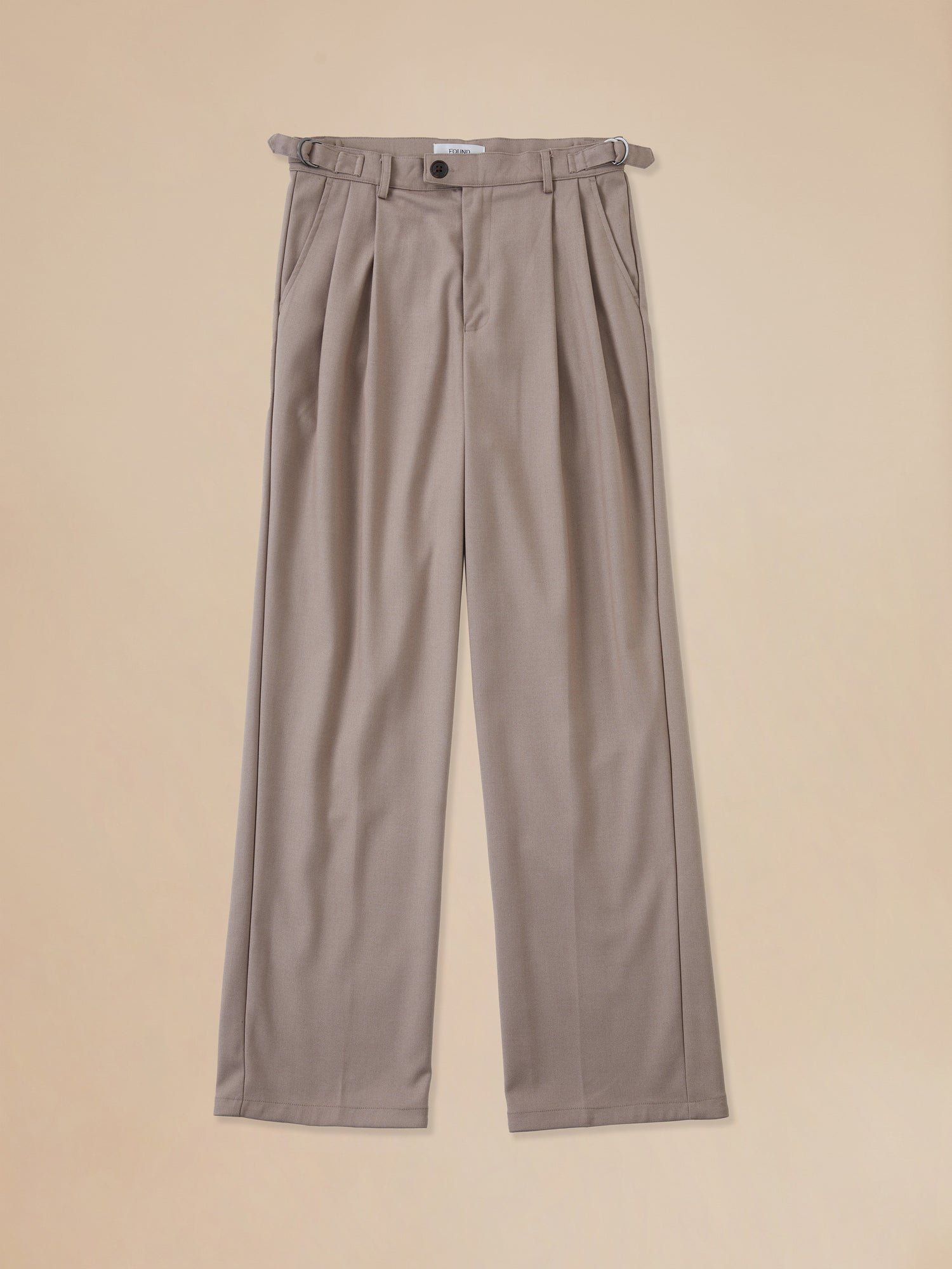 A pair of Pleated Trousers in beige by Found.
