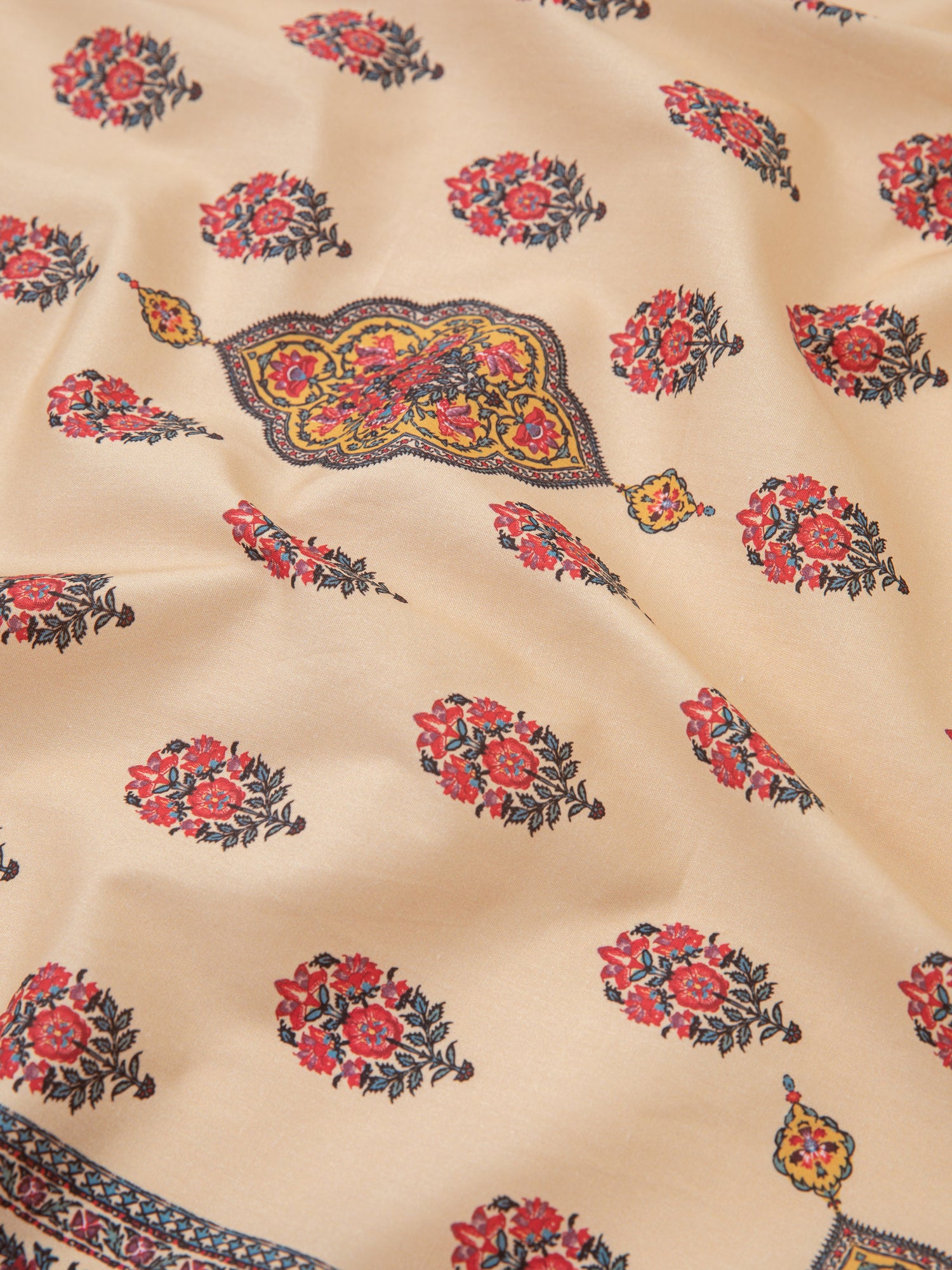 An airy Poinciana Bandana cotton blend fabric with Indo-Aryan prints in beige and red, from the brand Found.