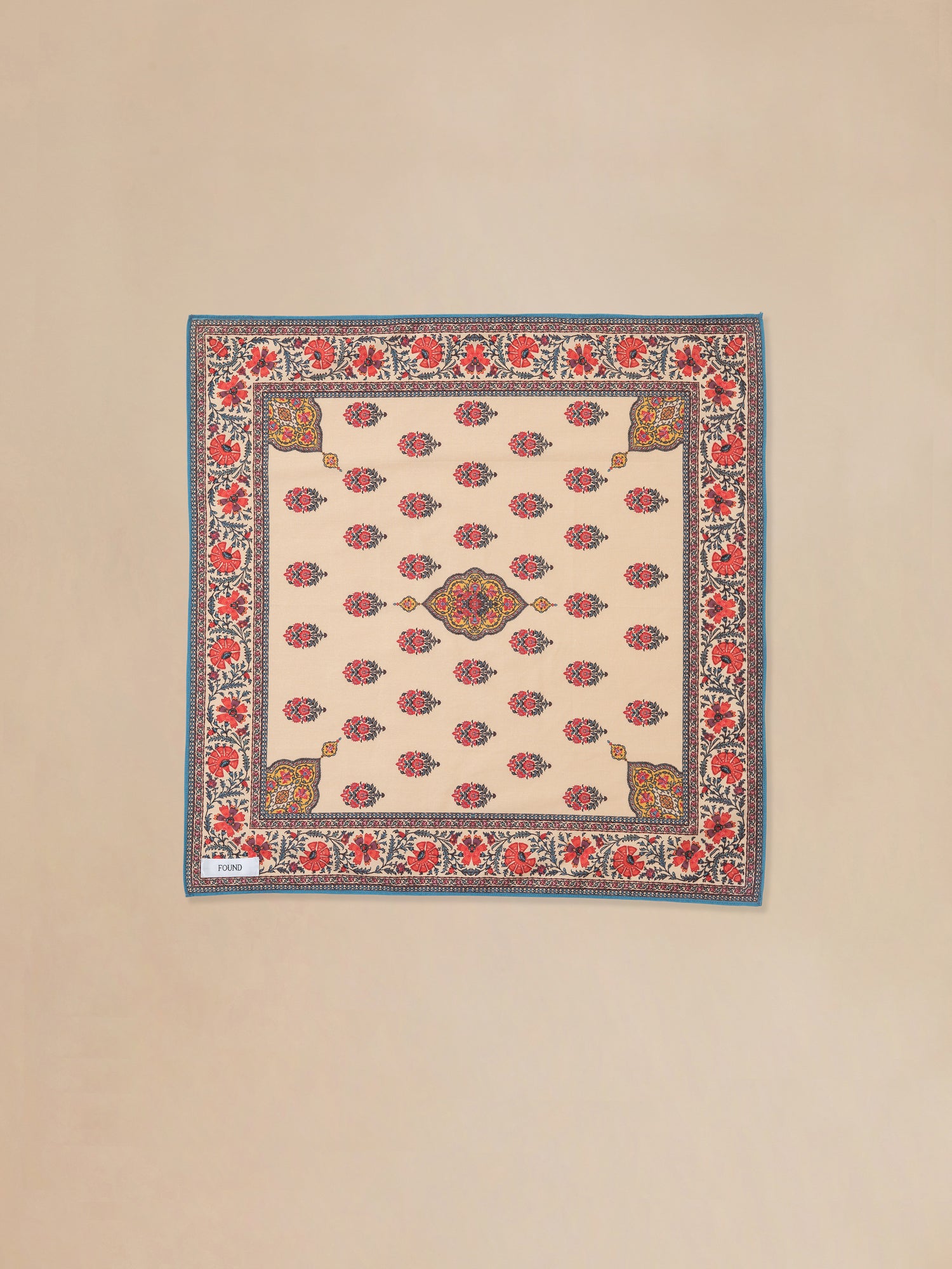 A beige and red Poinciana Bandana rug with an Indo-Aryan floral pattern by Found.
