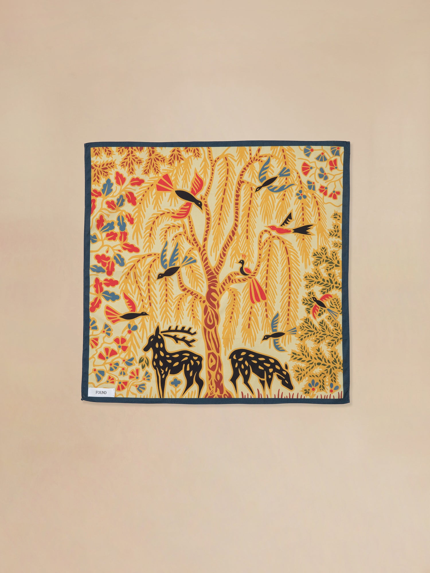 A pre-order Rainforest Bandana with a painting of a deer and a tree featuring Phulkari artwork by Found.