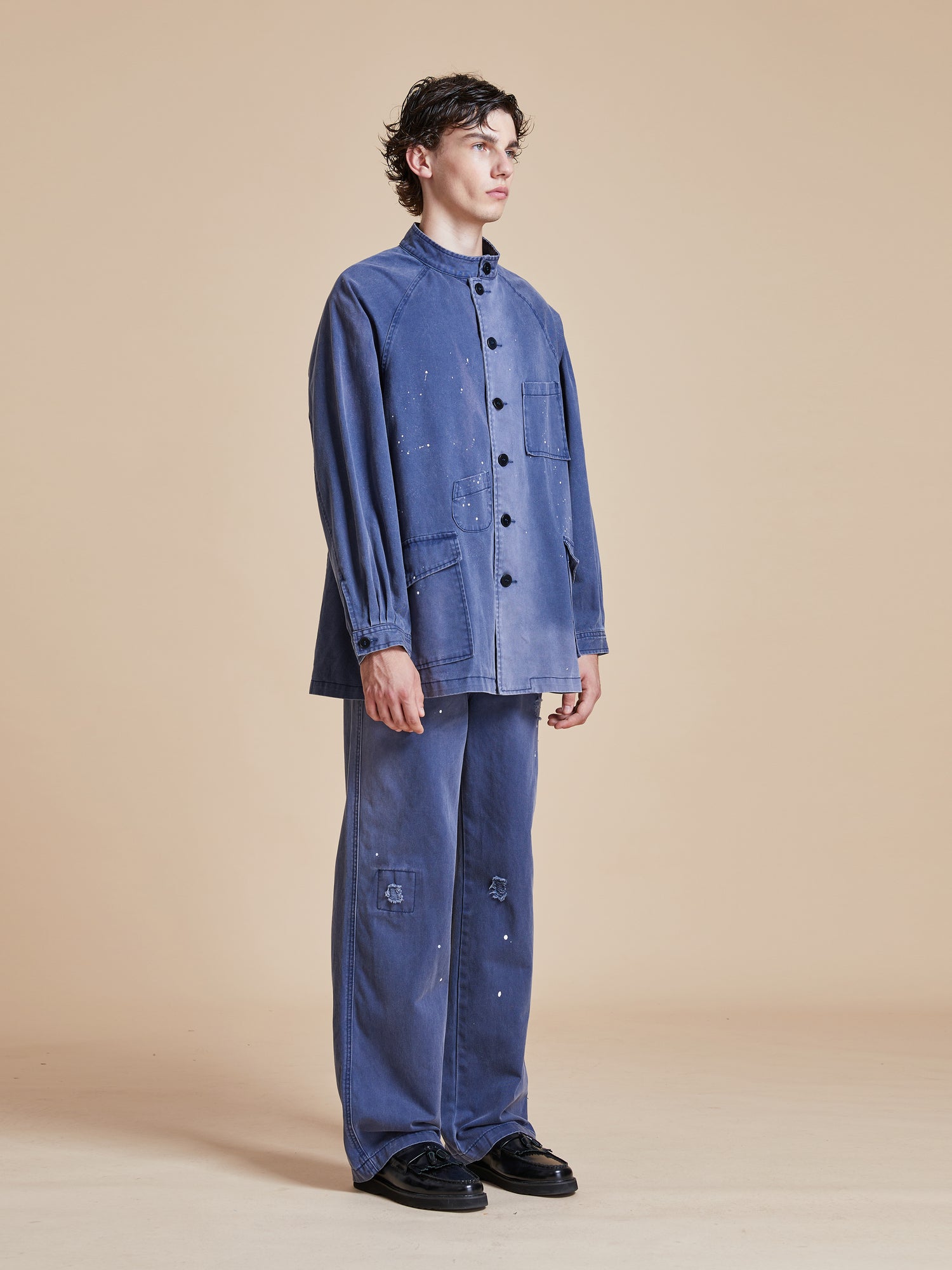 The model is wearing a River Painters Chore Coat denim shirt and pants by Found.