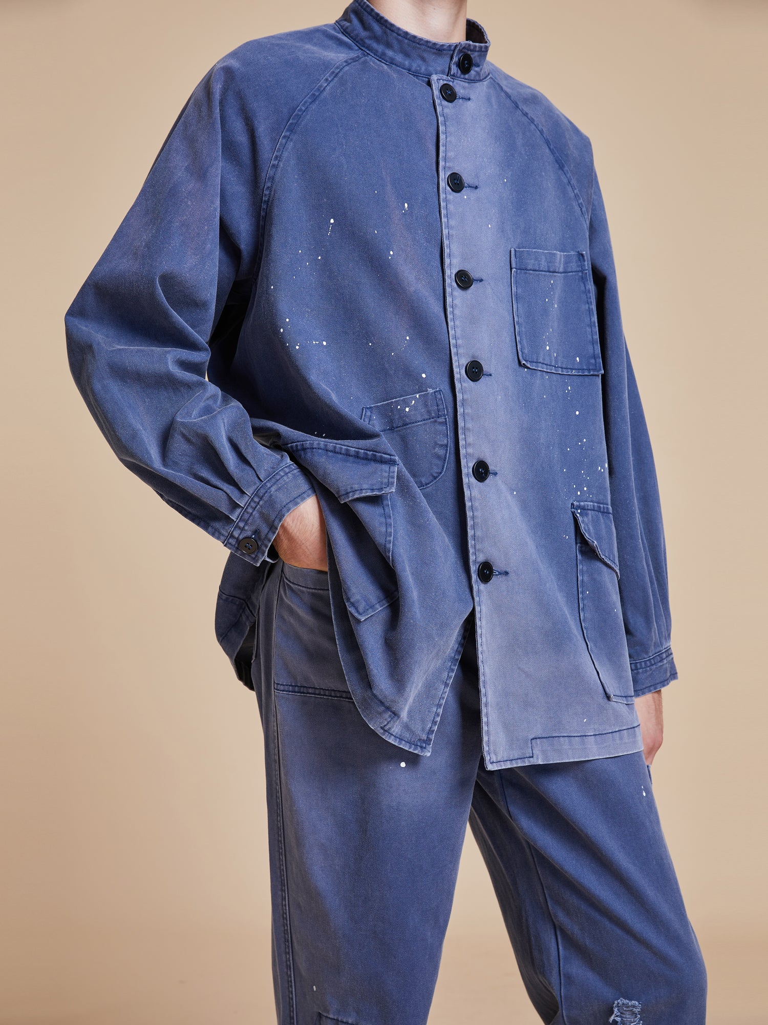 A model wearing a Found River Painters Chore Coat and pants.