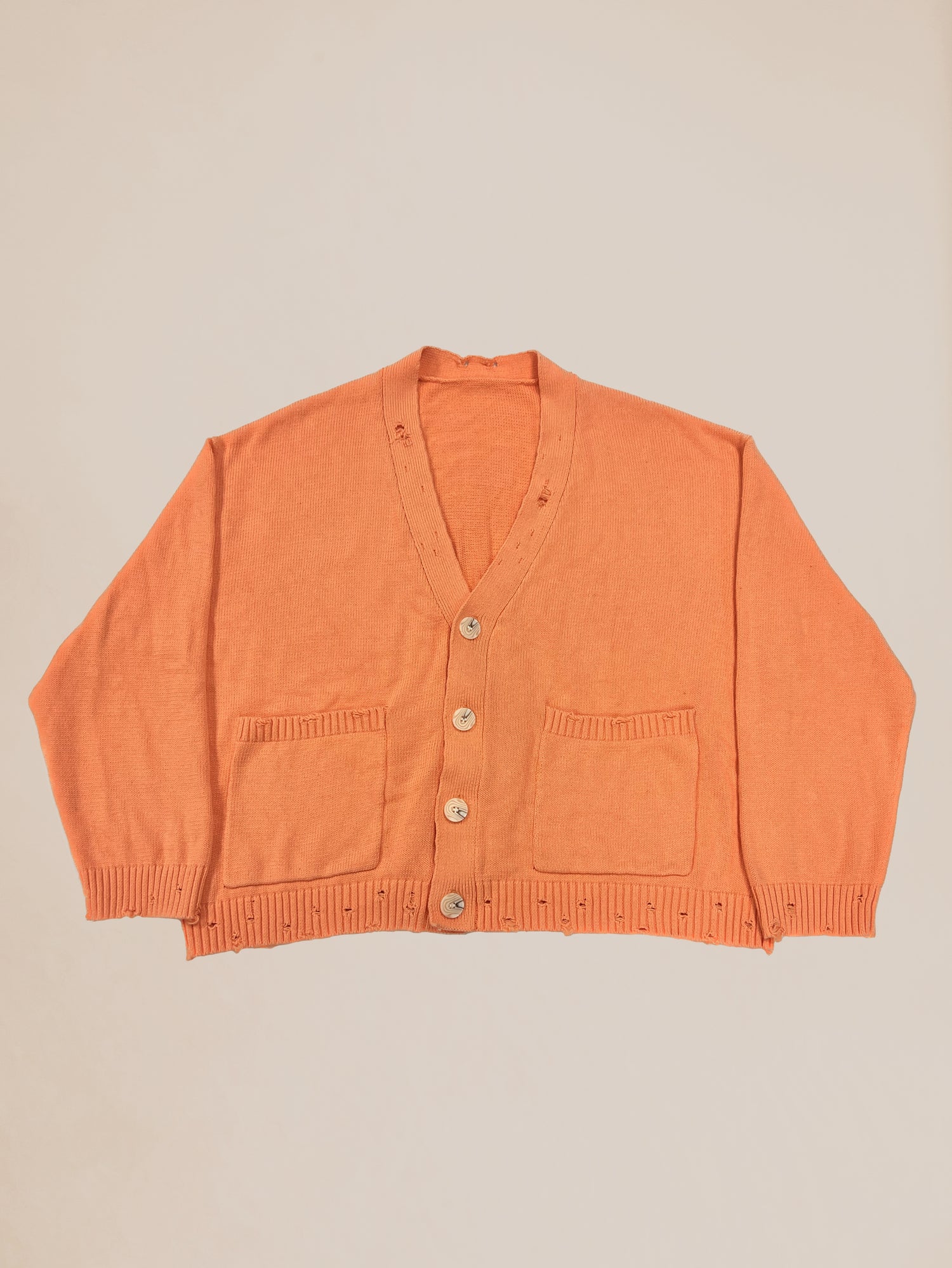 Orange Profound Sample 22 distressed knitted cardigan sweater with buttons displayed on a neutral background.