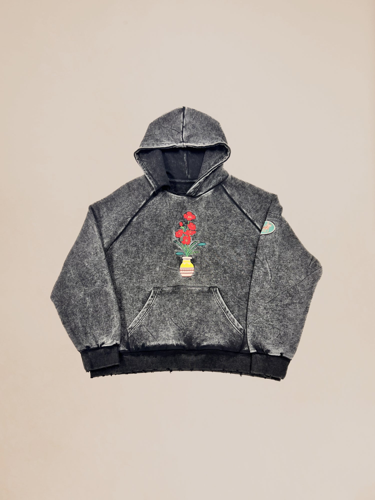 Gray hooded sweatshirt with floral embroidery and patches on a neutral background, offered in our Profound Sample 28 (Dyed Vase Pot Hoodie) Sale.