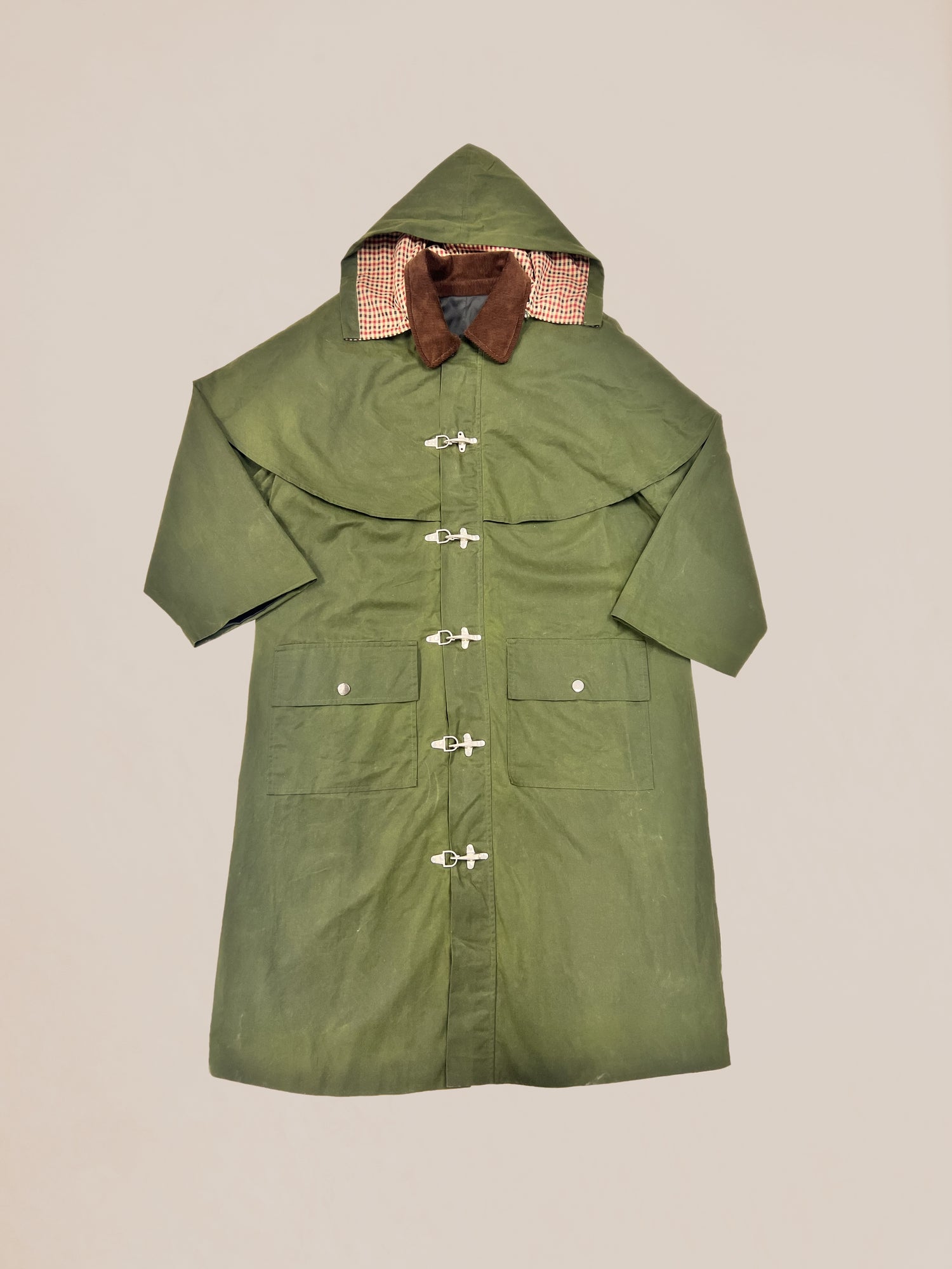Olive green polyester coat with toggle buttons and a checkered lining on the collar displayed against a neutral background. 
Product Name: Olive Buckle Coat (Sample 41)
Brand Name: Profound