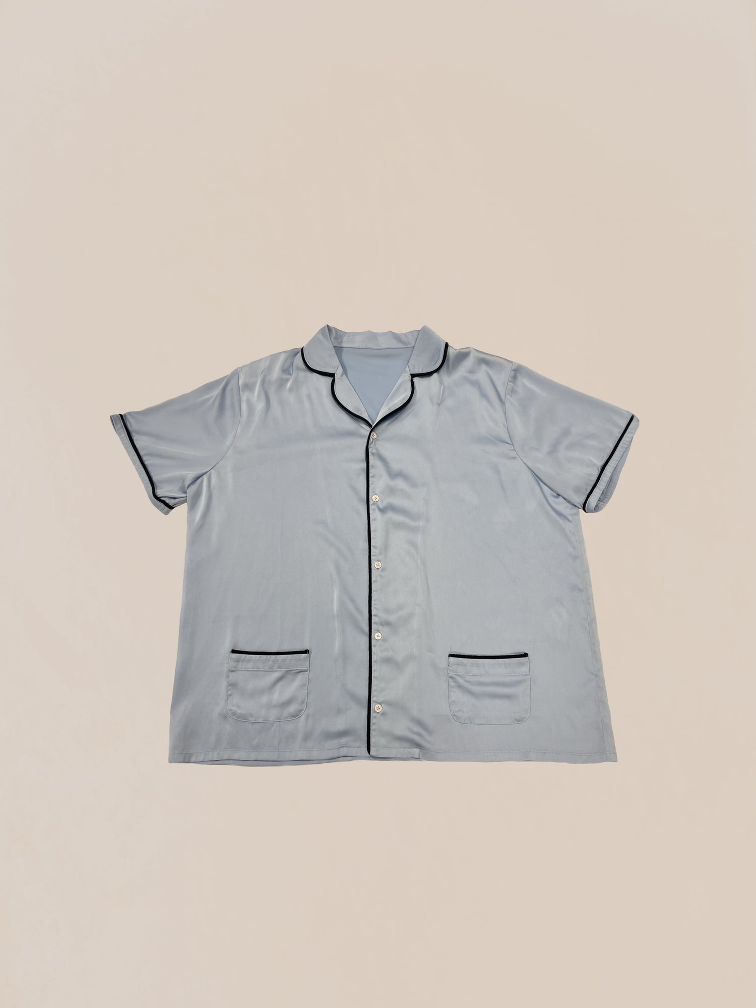 A Sample 61 (Light Blue Camp Shirt) made by Profound, with short sleeves and a collar, laid flat on a plain background as a pre-production sample.