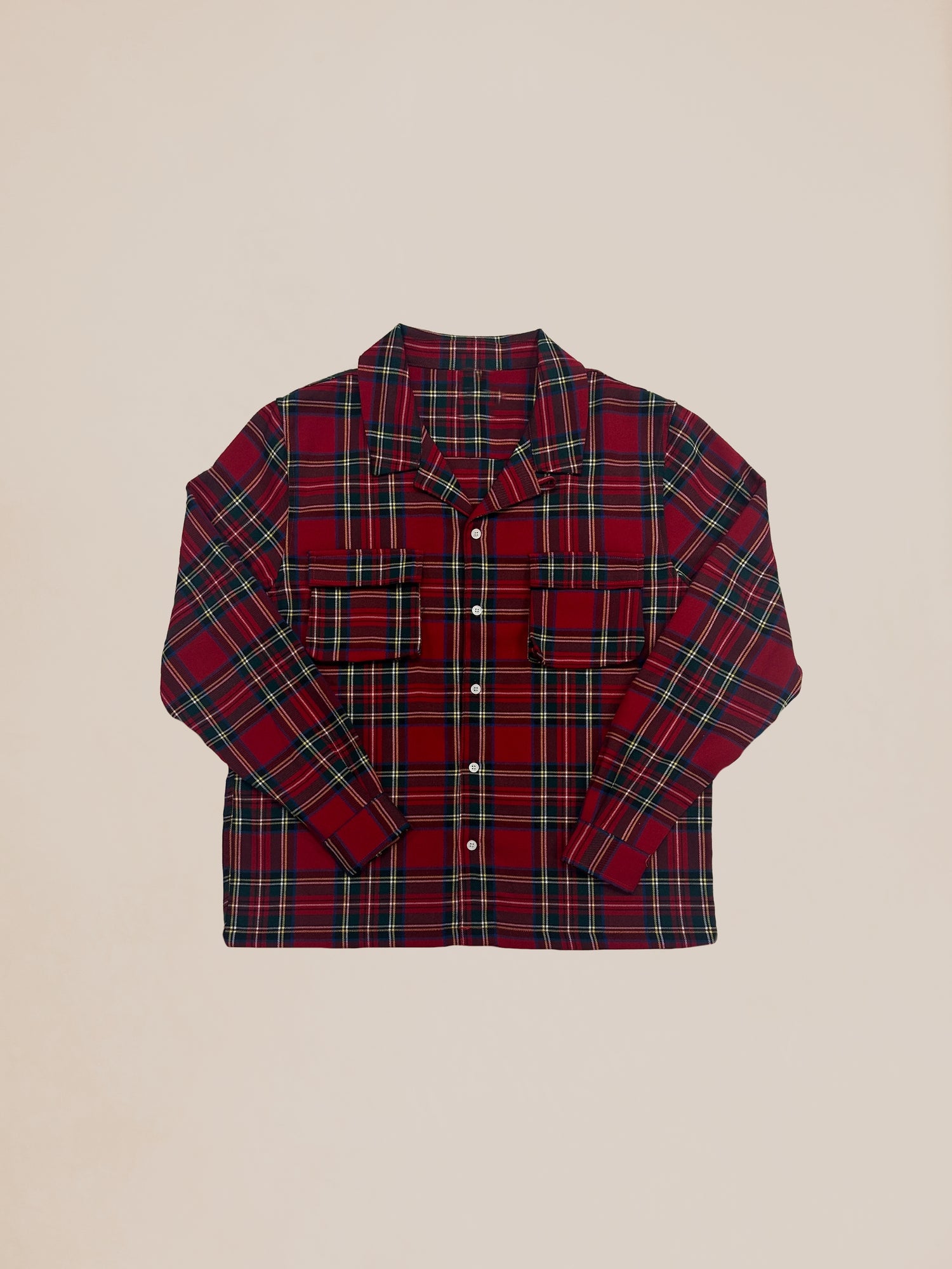 A red Sample 70 plaid long sleeve camp shirt by Profound laid flat on a light background.