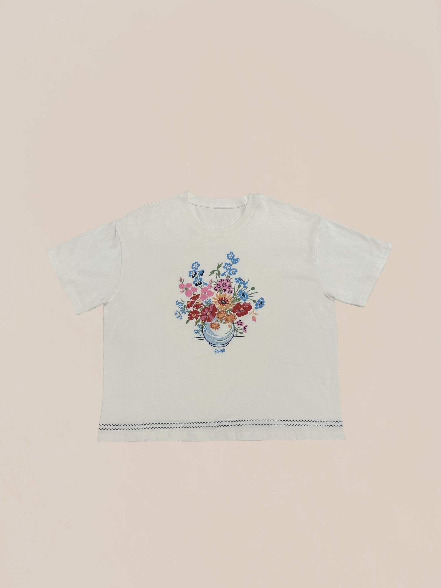 100% Cotton white t-shirt with Profound's Sample 79 (Bouquet Flowers Tee) design centered on the front against a pale pink background.