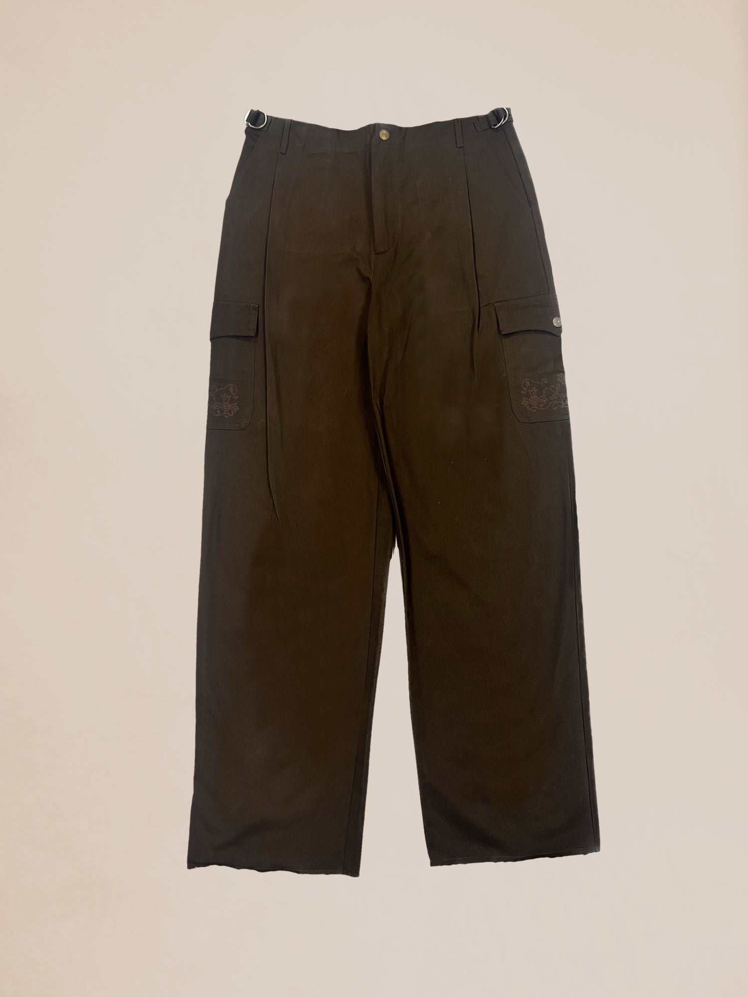 A pair of brown wide-legged cotton pants with decorative pockets on a neutral background - Profound's Sample 9 Western Cargo Jeans.