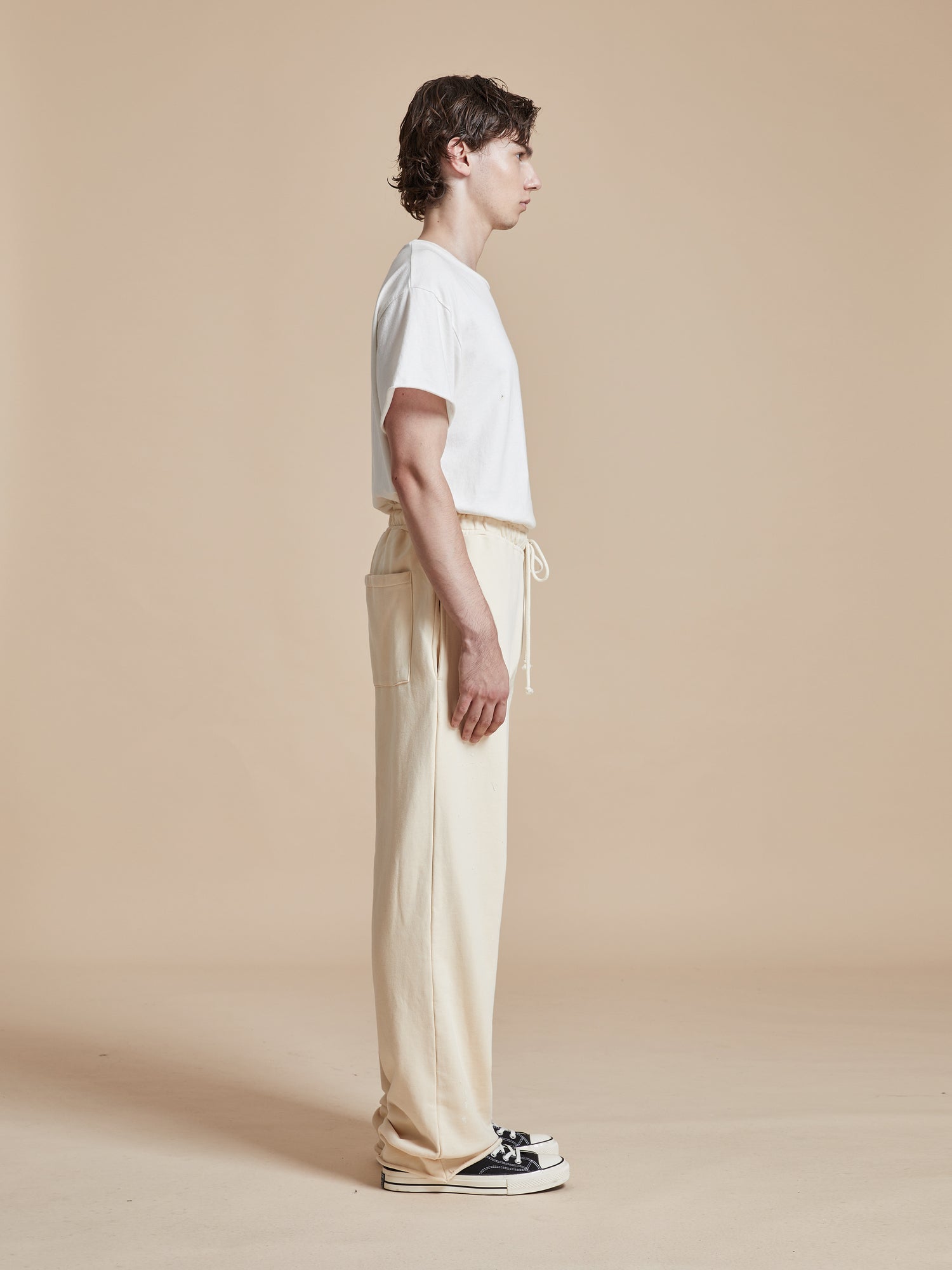 A man wearing Found's Sandshell Lounge Pants, a wardrobe staple.
