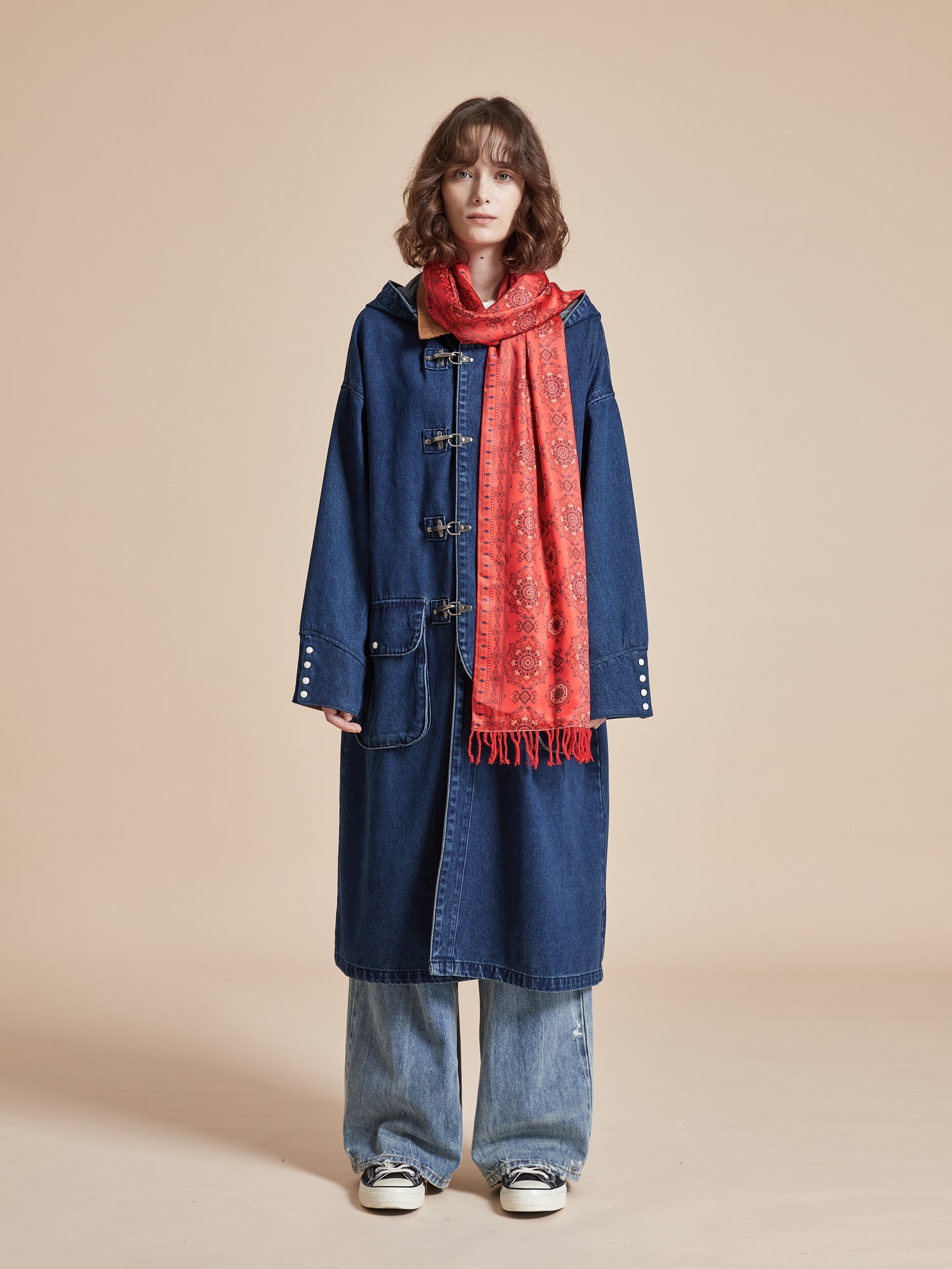 A woman wearing a Sargasso Denim Buckle Coat and Found scarf.