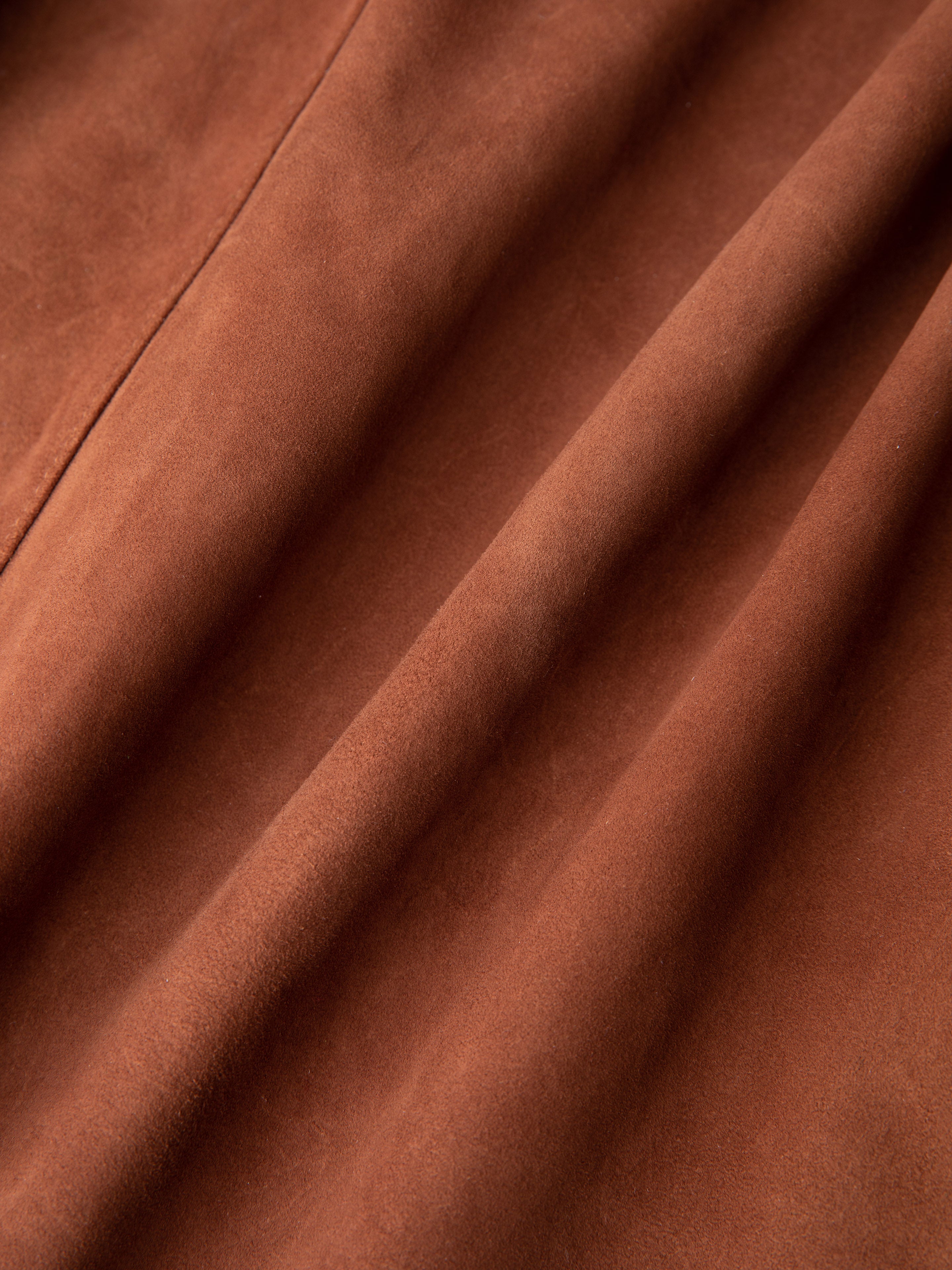 Close-up of FOUND's Suede Camp Shirt in genuine goat suede leather, showcasing its smooth texture and natural earthy tone, perfect for creating a relaxed silhouette.