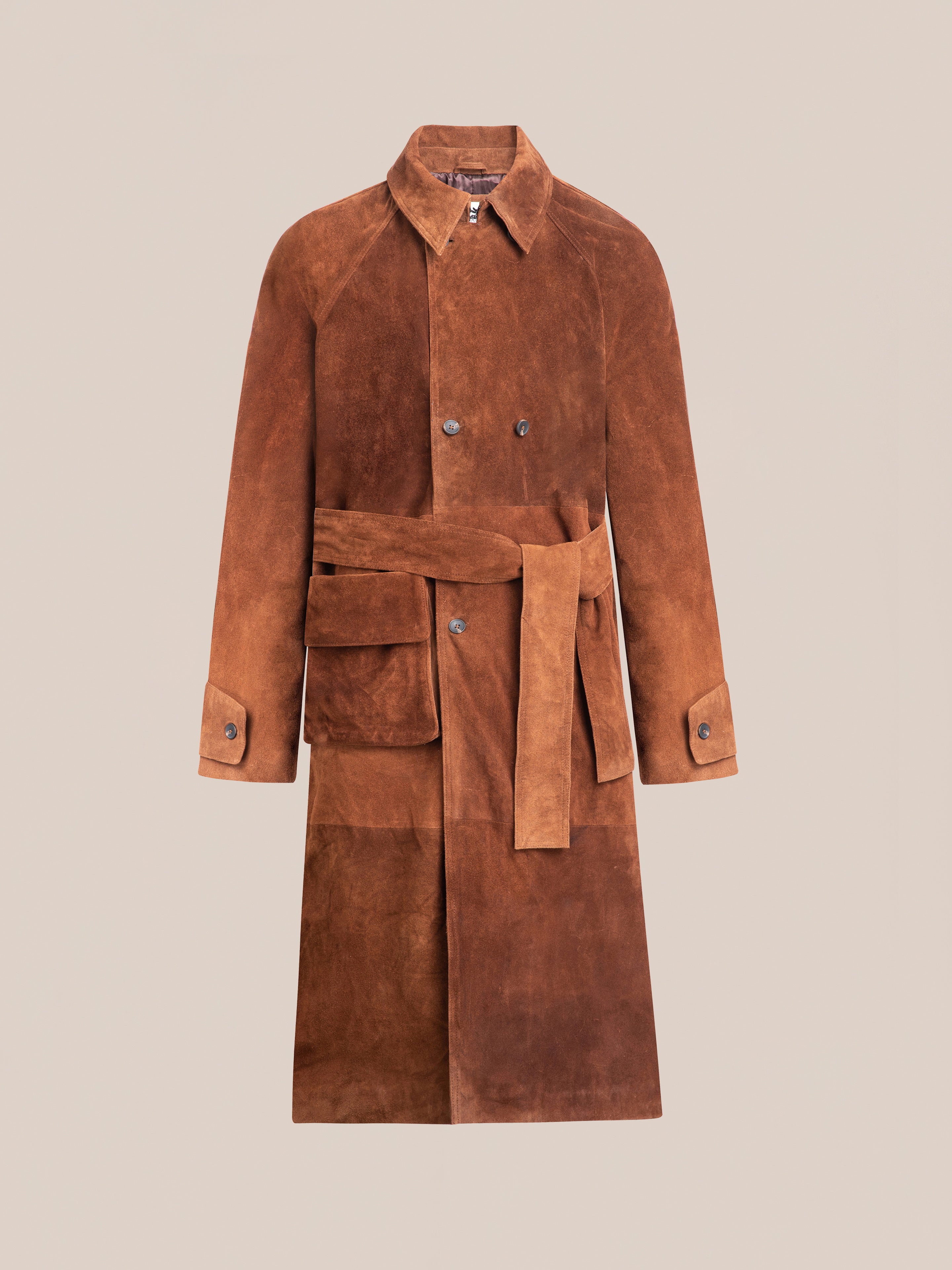 The FOUND Suede Leather Trench Coat features a unisex relaxed fit with cow suede, notched collar, double-breasted buttons, and a matching belt, set against a plain background.