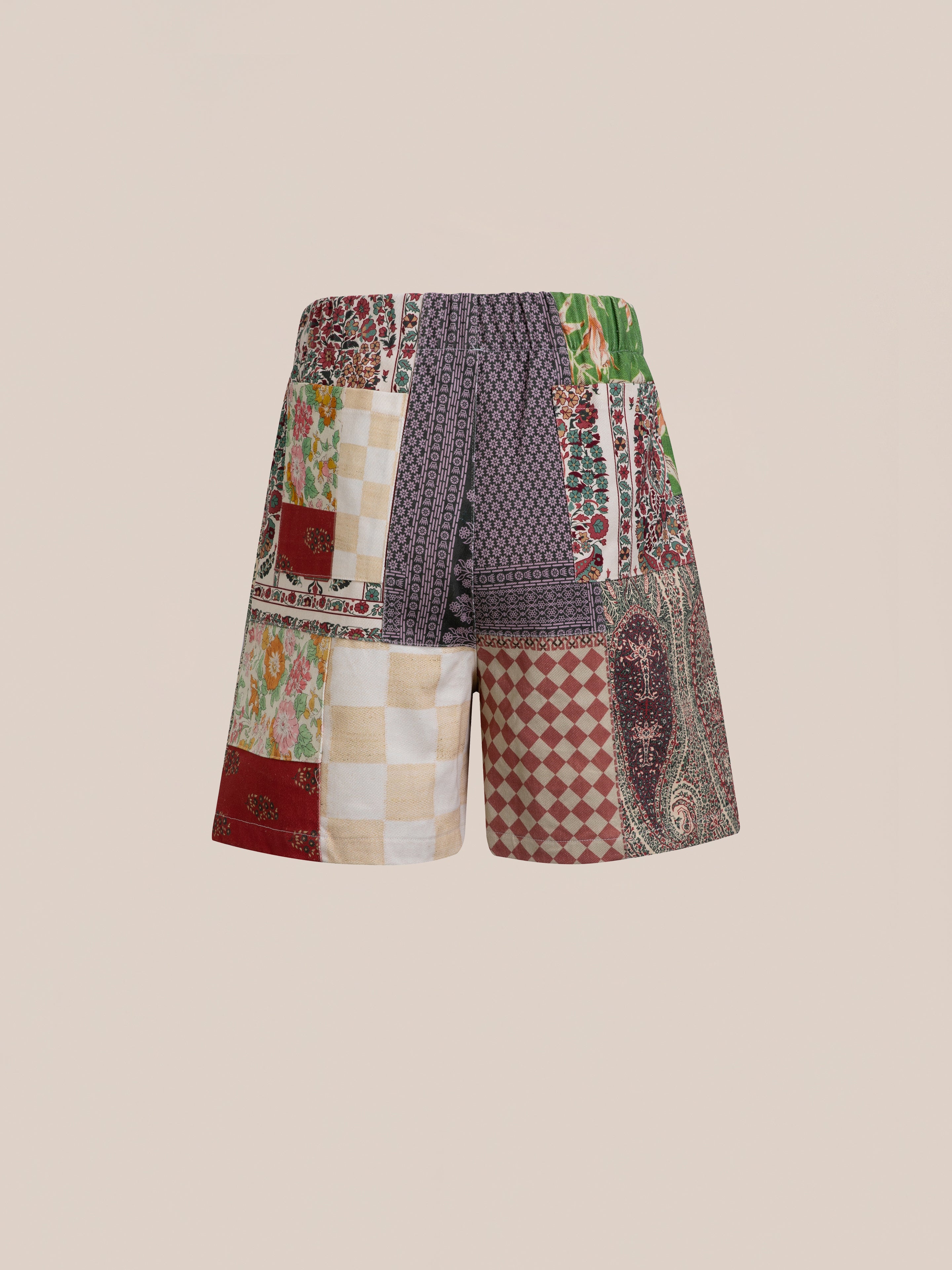 Tapestry Twill Shorts from FOUND, featuring a patchwork design with checkered, floral, and paisley patterns in various colors on a plain background.