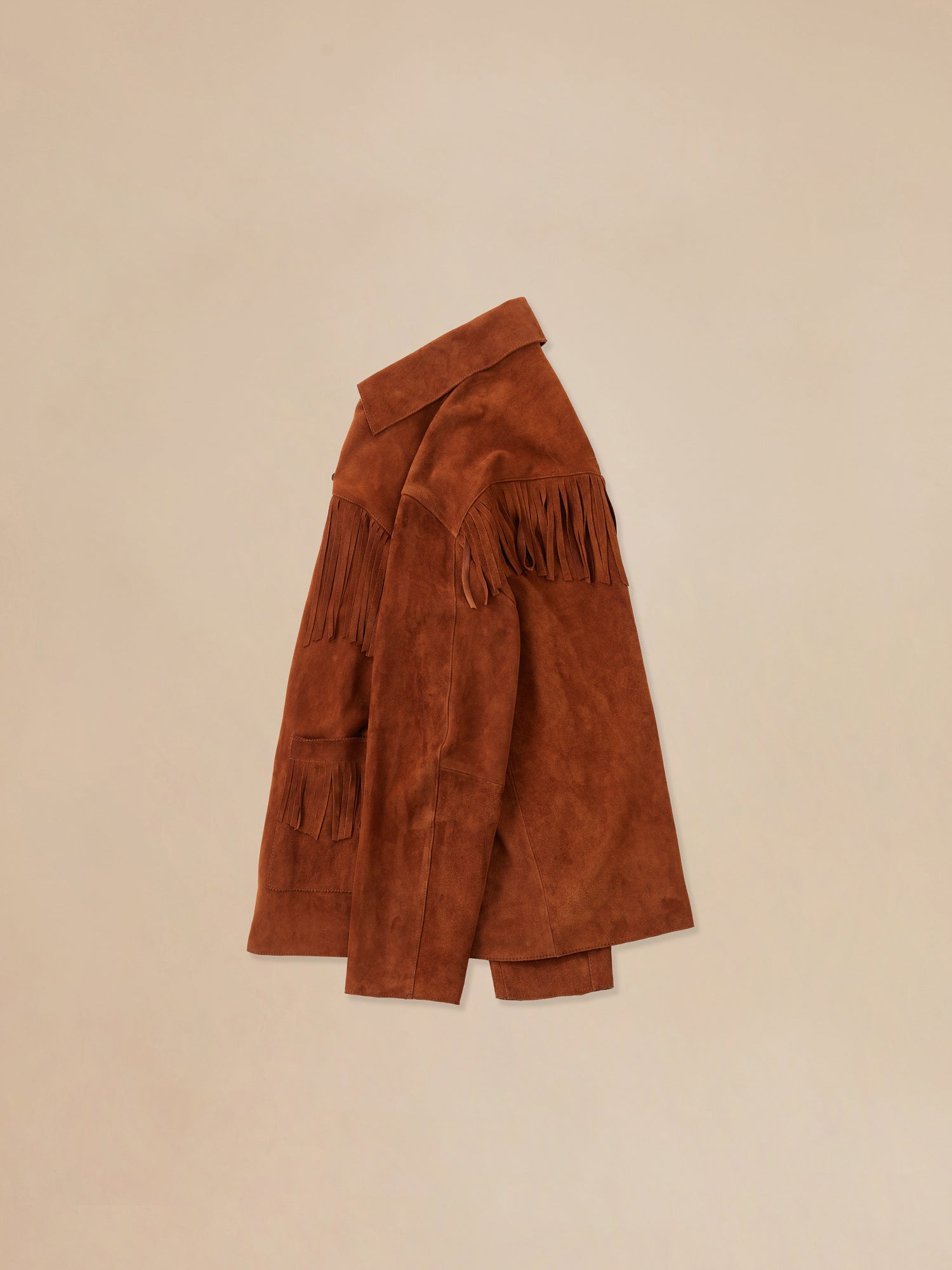 Side view of the tobacco fringe suede buckle jacket from Found's Fall 2023 collection