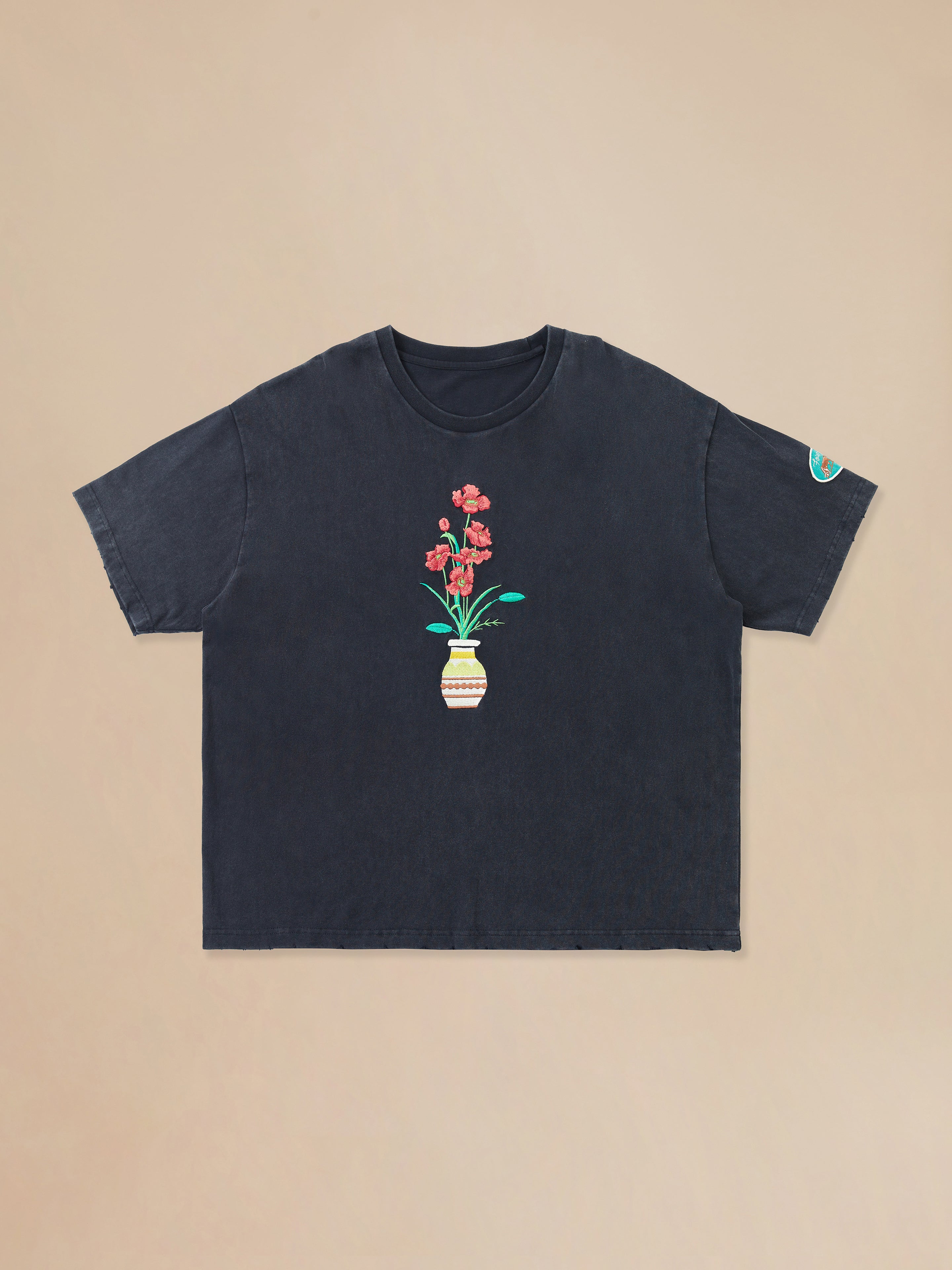 A Flower Vase Tee with a flower in a pot by Found.