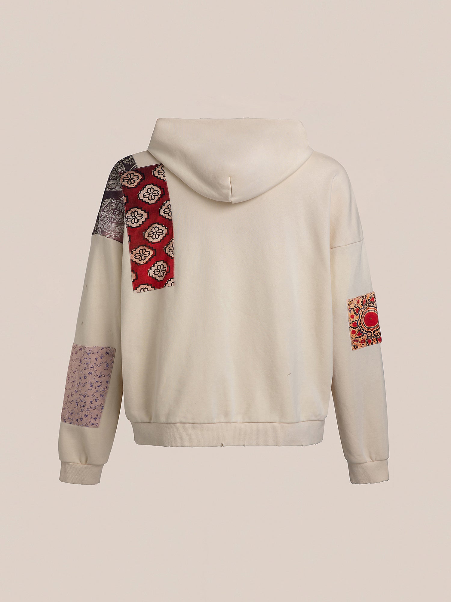 FOUND's Tapestry Patchwork Zip Up Hoodie features an oversized fit, highlighted by patchwork designs on the sleeves and hood in red, purple, and intricate South Asian tapestry patterns.