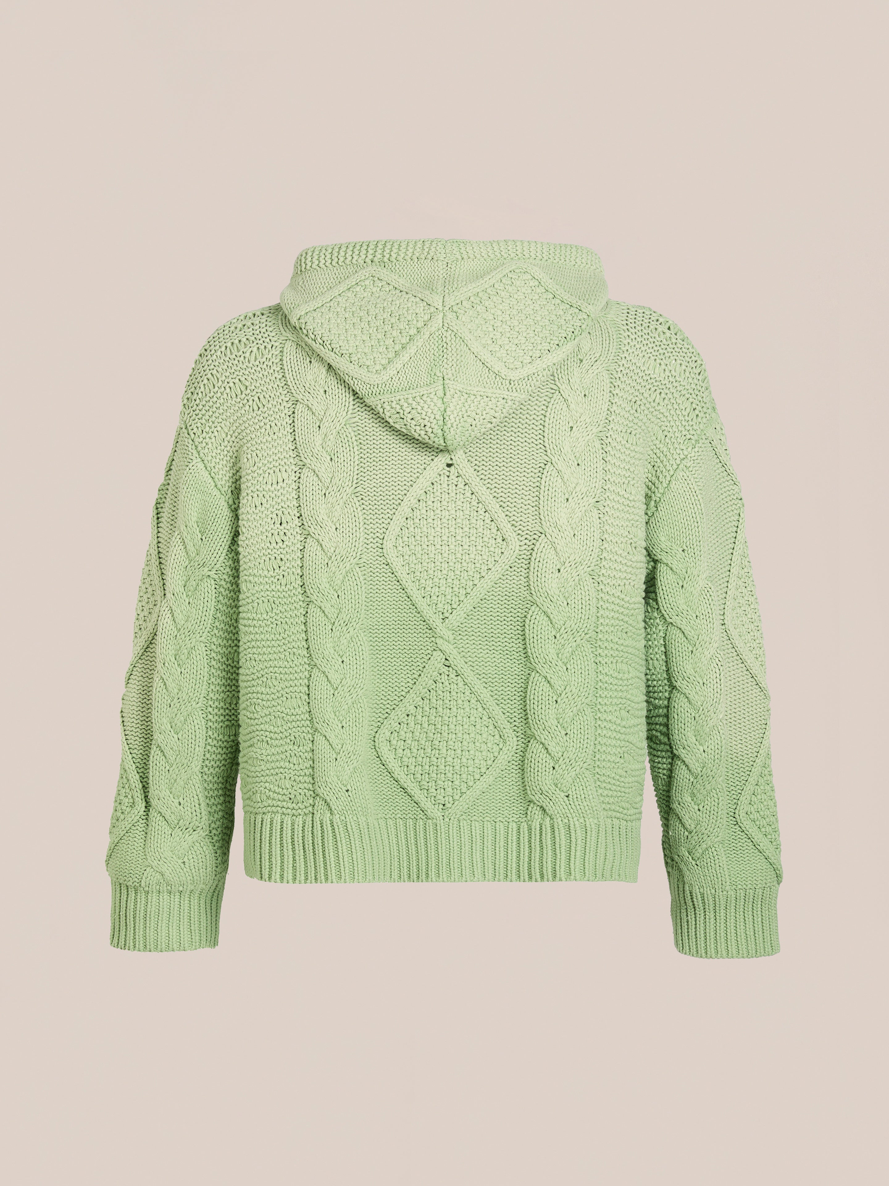 Found's Zip Up Cable Knit Hoodie in light green features a hood and back pattern. Crafted from heavyweight cotton blend, it offers a unisex relaxed fit, displayed against a plain beige background.