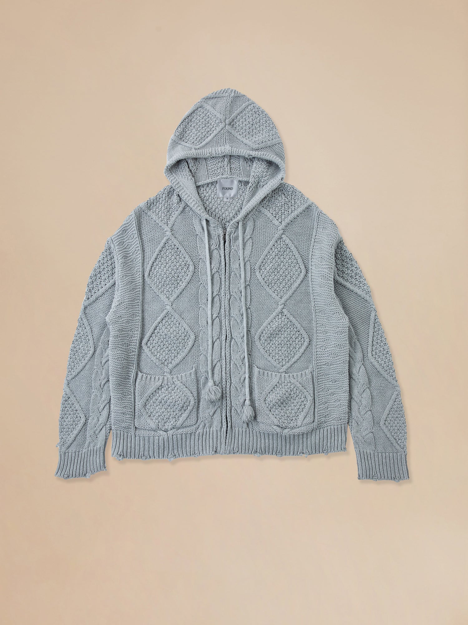 A cozy Zip Up Distressed Cable Knit Hoodie sweater in blue from Found.