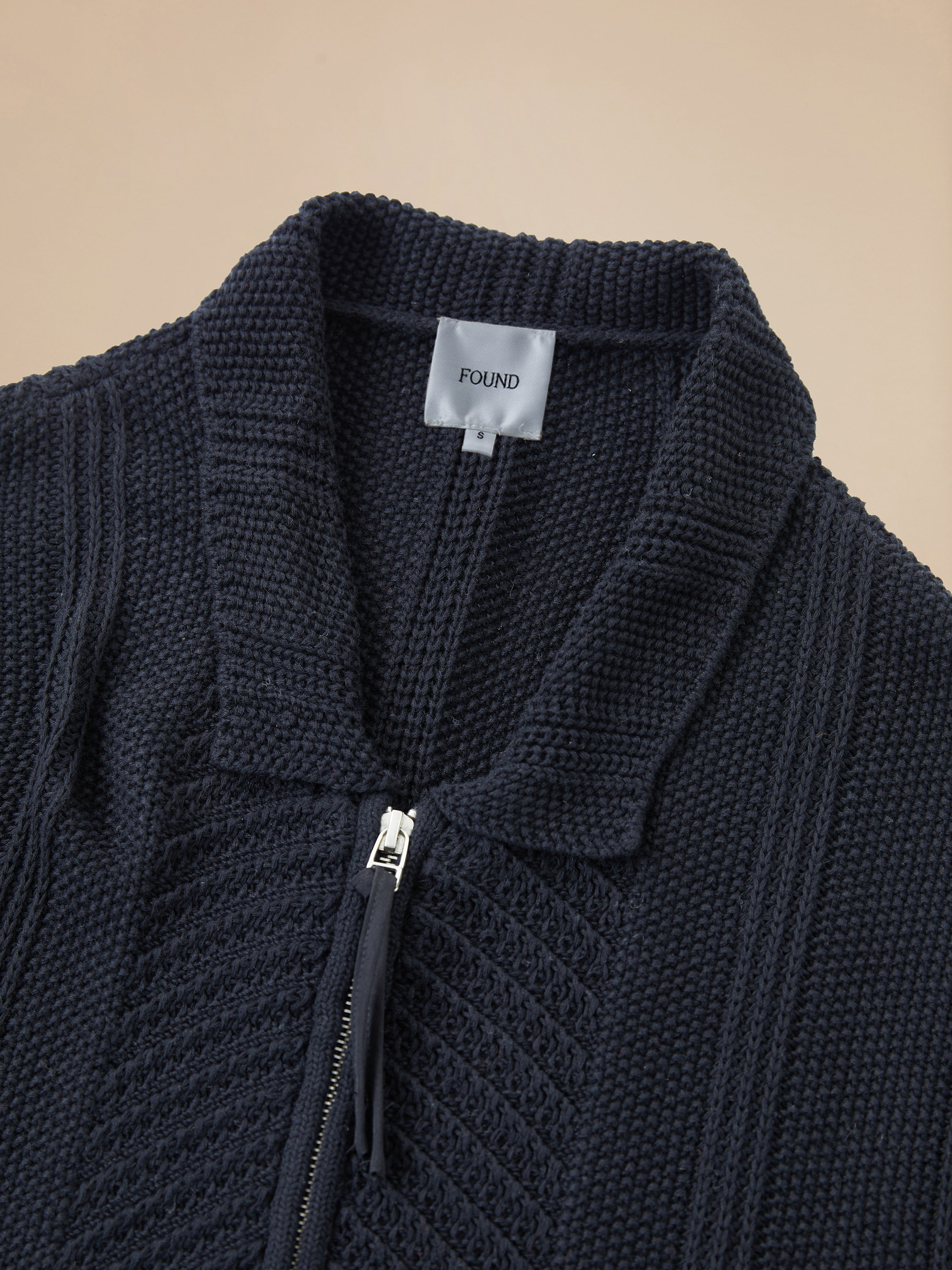 A black Zip Up Panel Knit Ribbed Sweater jacket with a zipper on the back by Found.