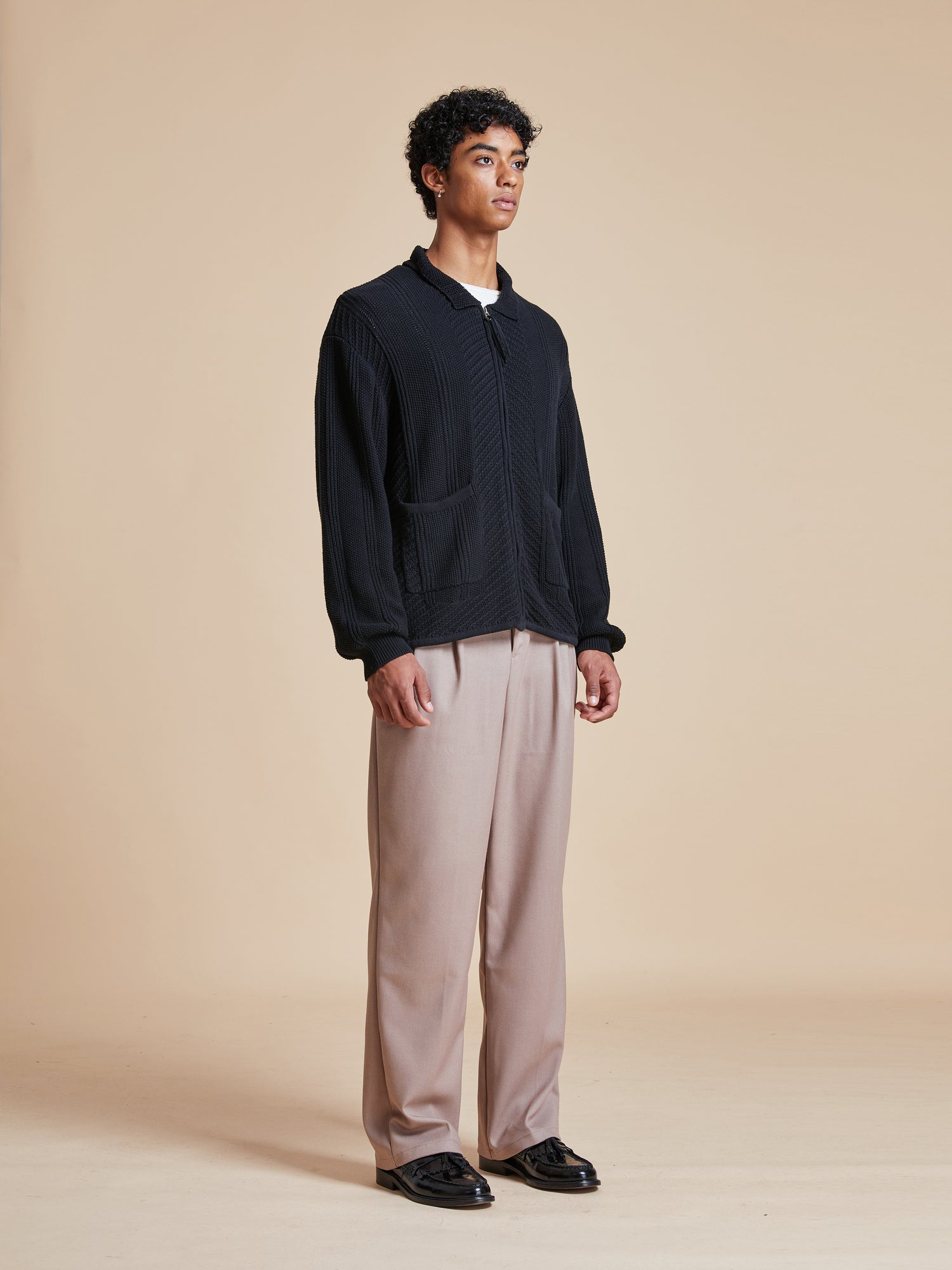 The model is wearing a Found Zip Up Panel Knit Ribbed Sweater.