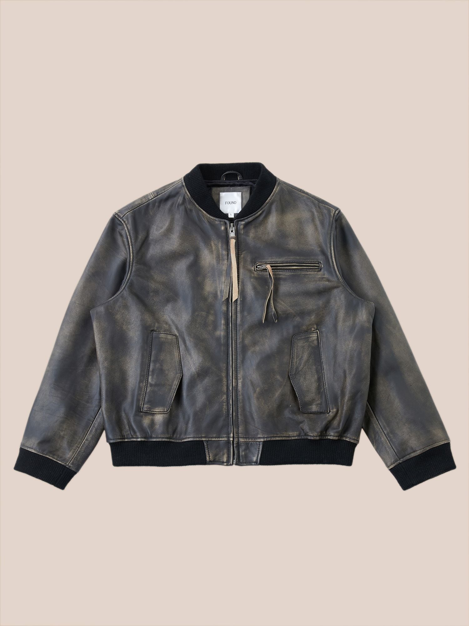 A Found Distressed Pavement Leather Bomber Jacket with a front zipper, a zippered chest pocket, and black ribbed cuffs and hem, exuding an antique and aged feel.