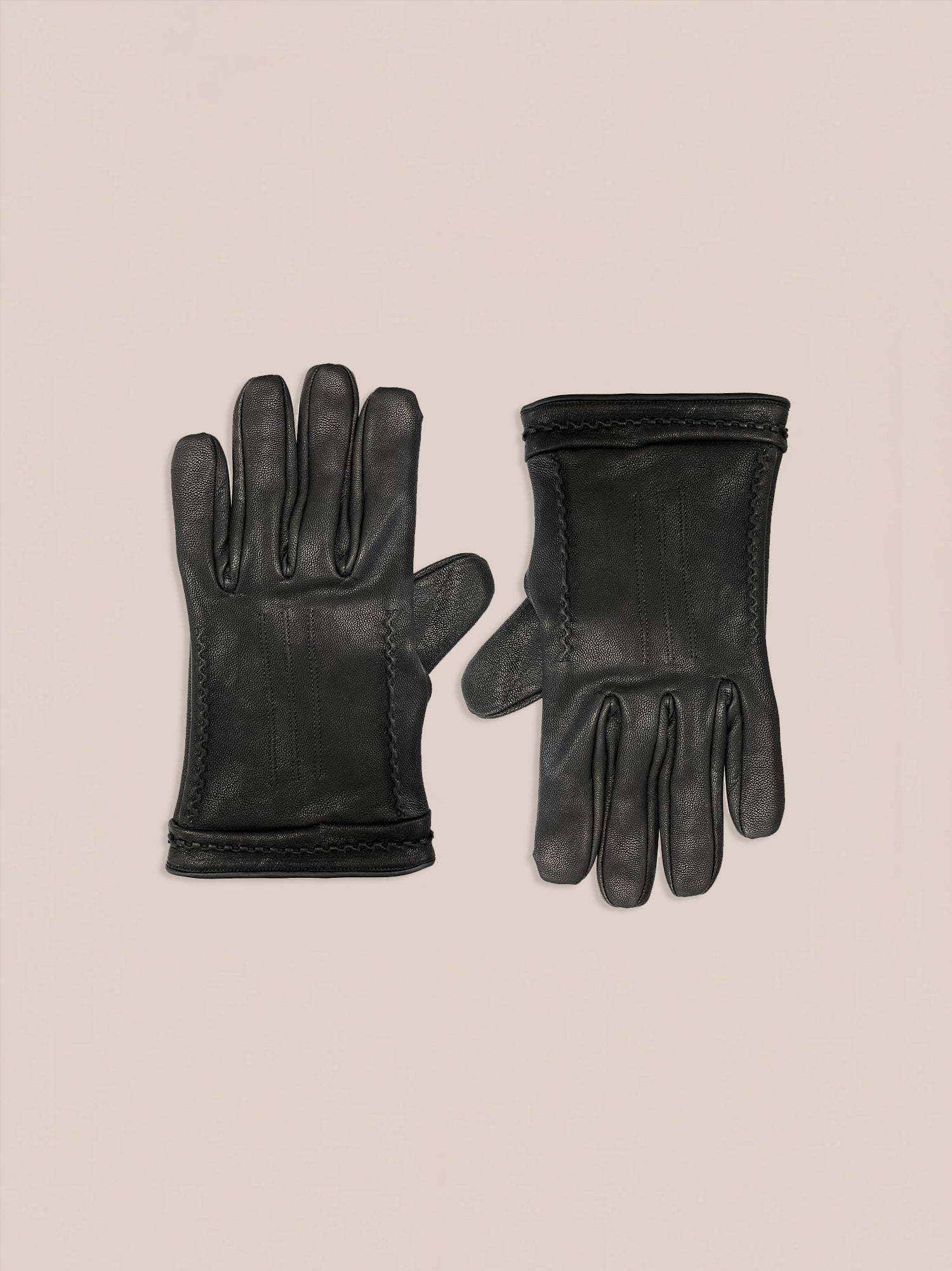 A pair of FOUND's Braided Leather Gloves in black leather featuring stitched detailing, displayed palm-up and palm-down against a neutral background.