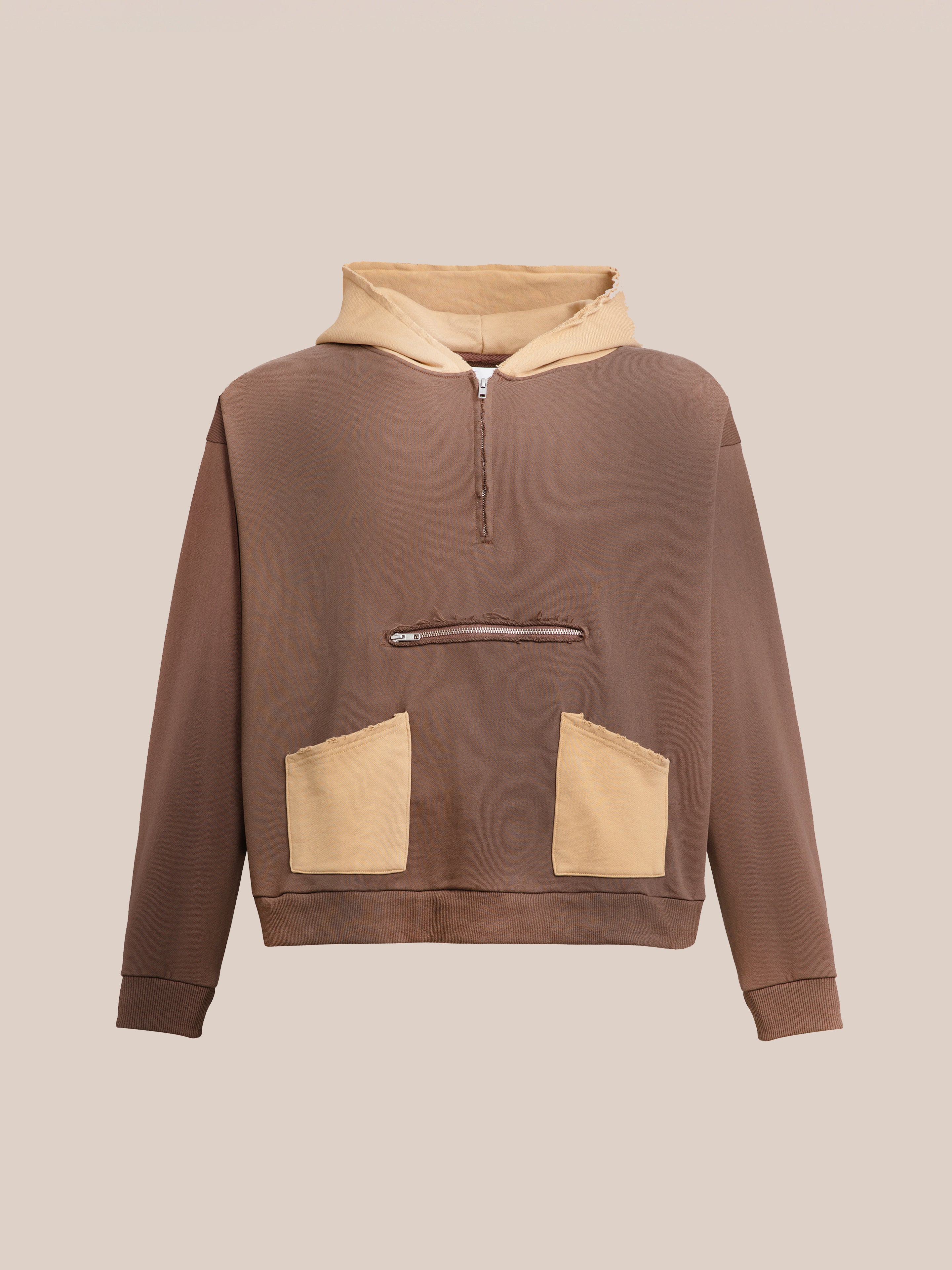 The Quarter Zip Two Tone Hoodie by FOUND is a brown hoodie with a vintage feel, showcasing a beige drawstring hood, two beige front pockets, and beige accents around the zip. It's crafted from soft French terry cotton.