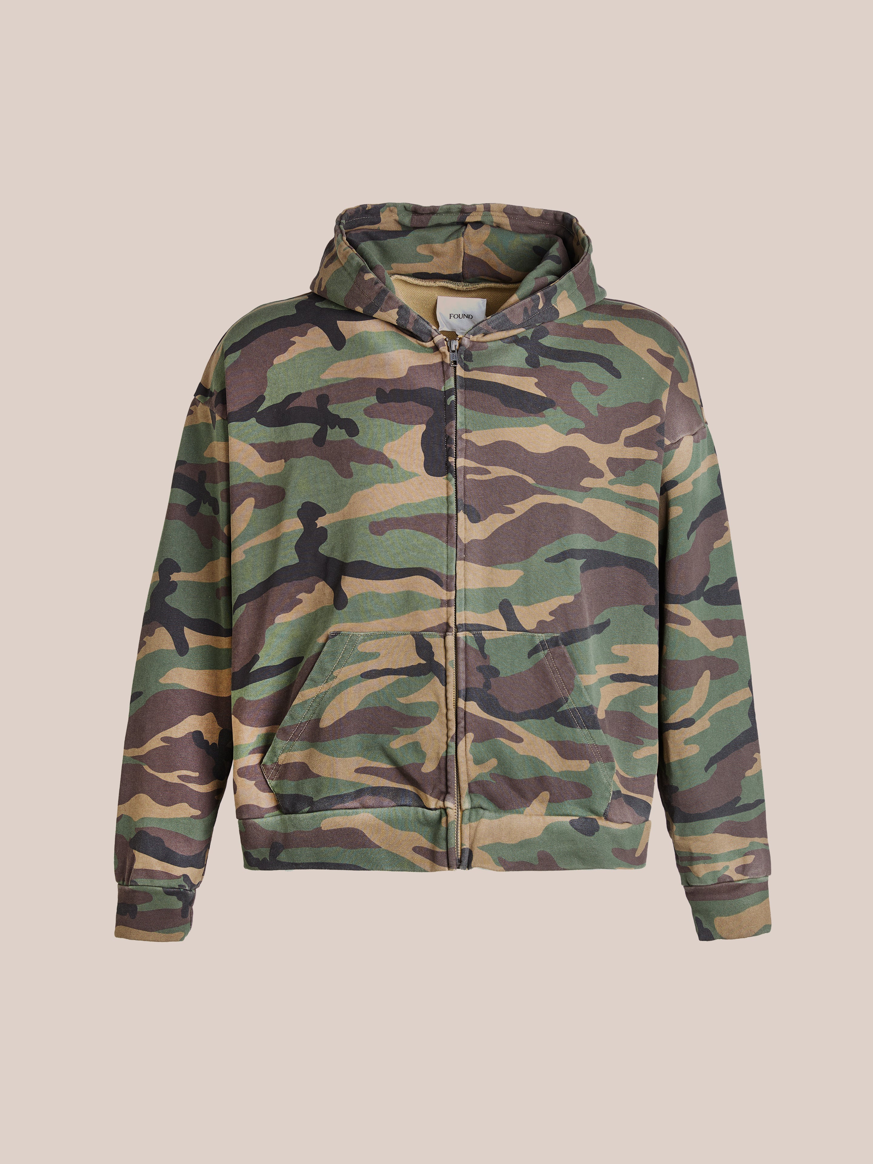 Enjoy ultimate comfort with FOUND's Washed Camouflage Zip Hoodie, showcasing a relaxed-fit and striking camo print.