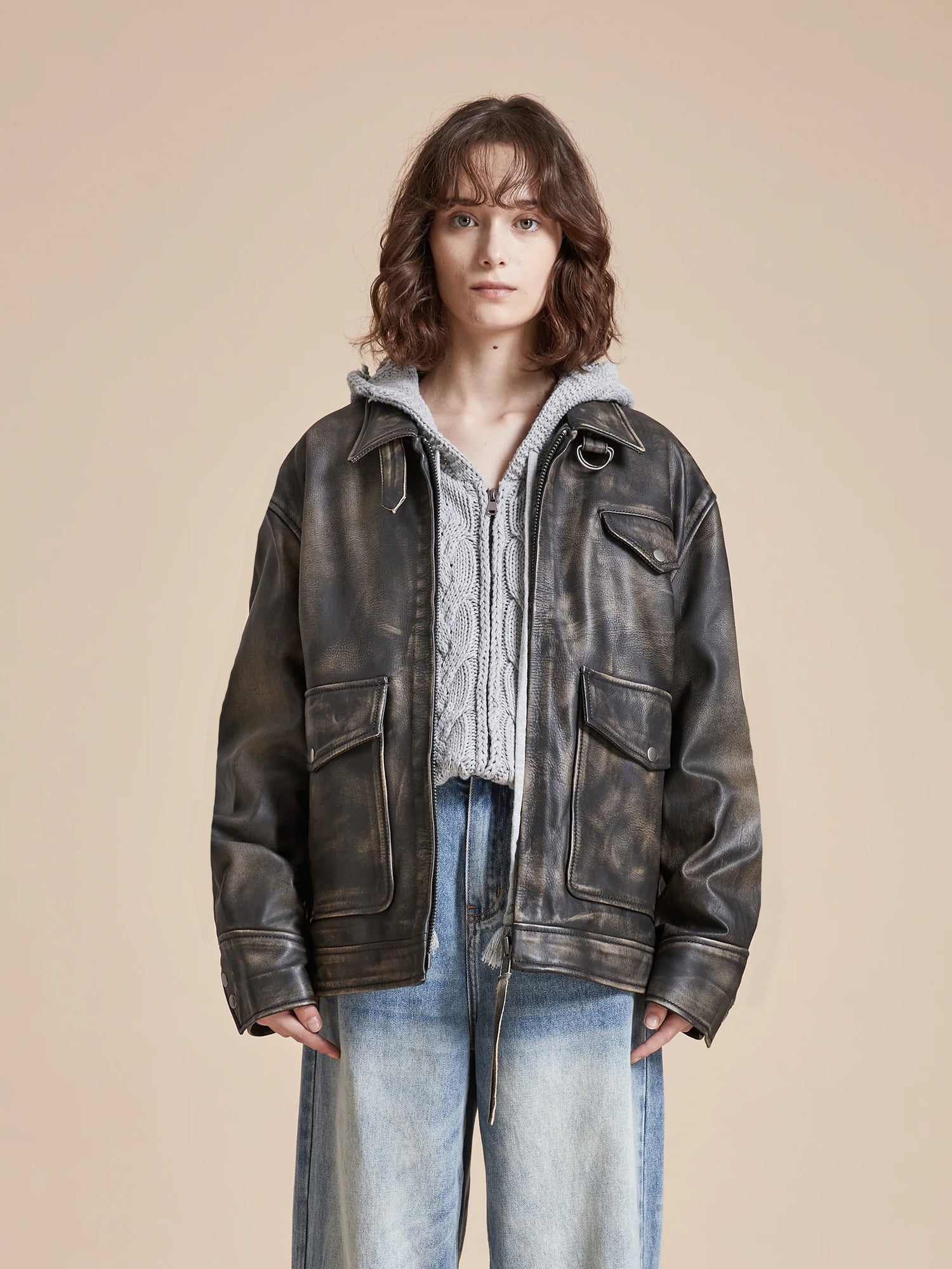 The model is wearing a Found distressed leather pocket jacket with jeans.