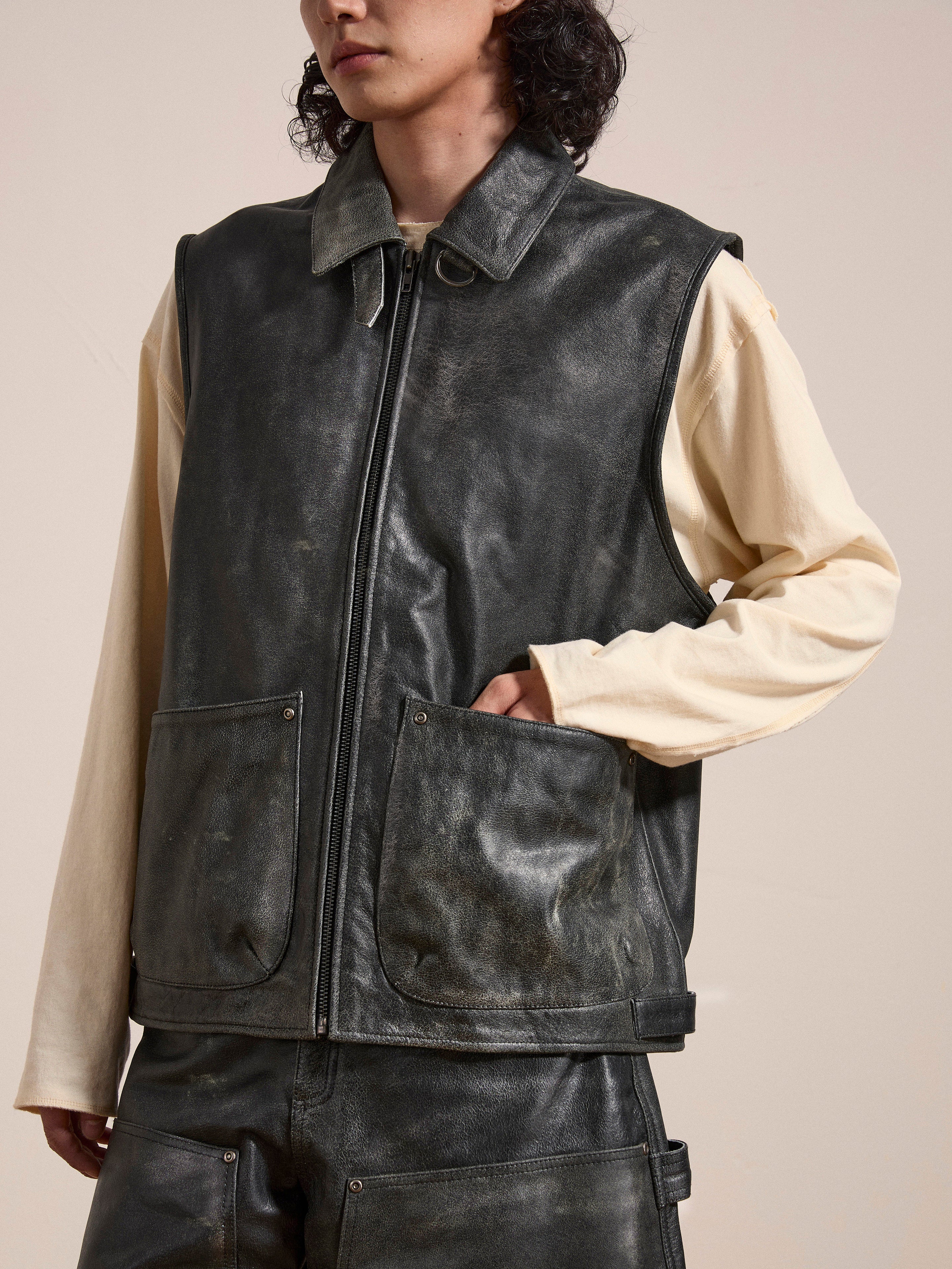 Person wearing a Found Distressed Genuine Leather Pocket Vest over a long-sleeved beige shirt and matching leather pants.