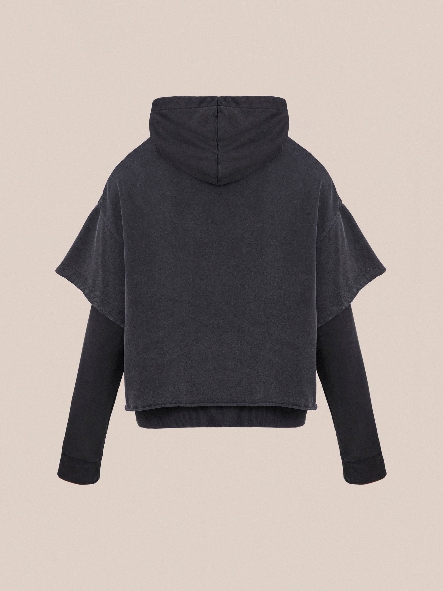 A vintage look black hooded sweatshirt, featuring short sleeves over long sleeves, crafted from soft french terry cotton and displayed from the back against a beige background. The product is the Double Layer Hoodie by Found.