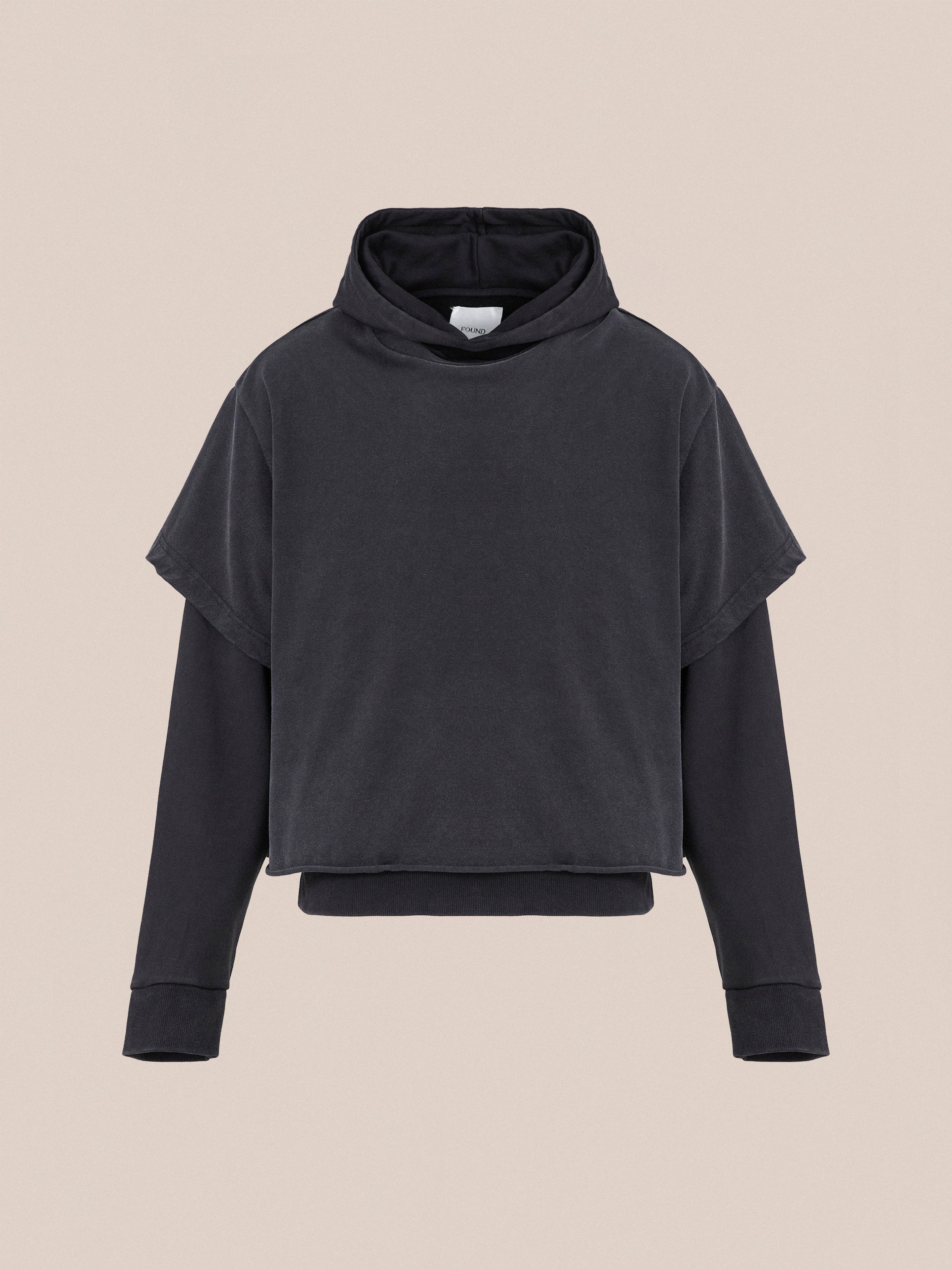 A vintage look black Double Layer Hoodie with long sleeves and a high neckline from Found is displayed against a beige background, crafted from soft French terry cotton.