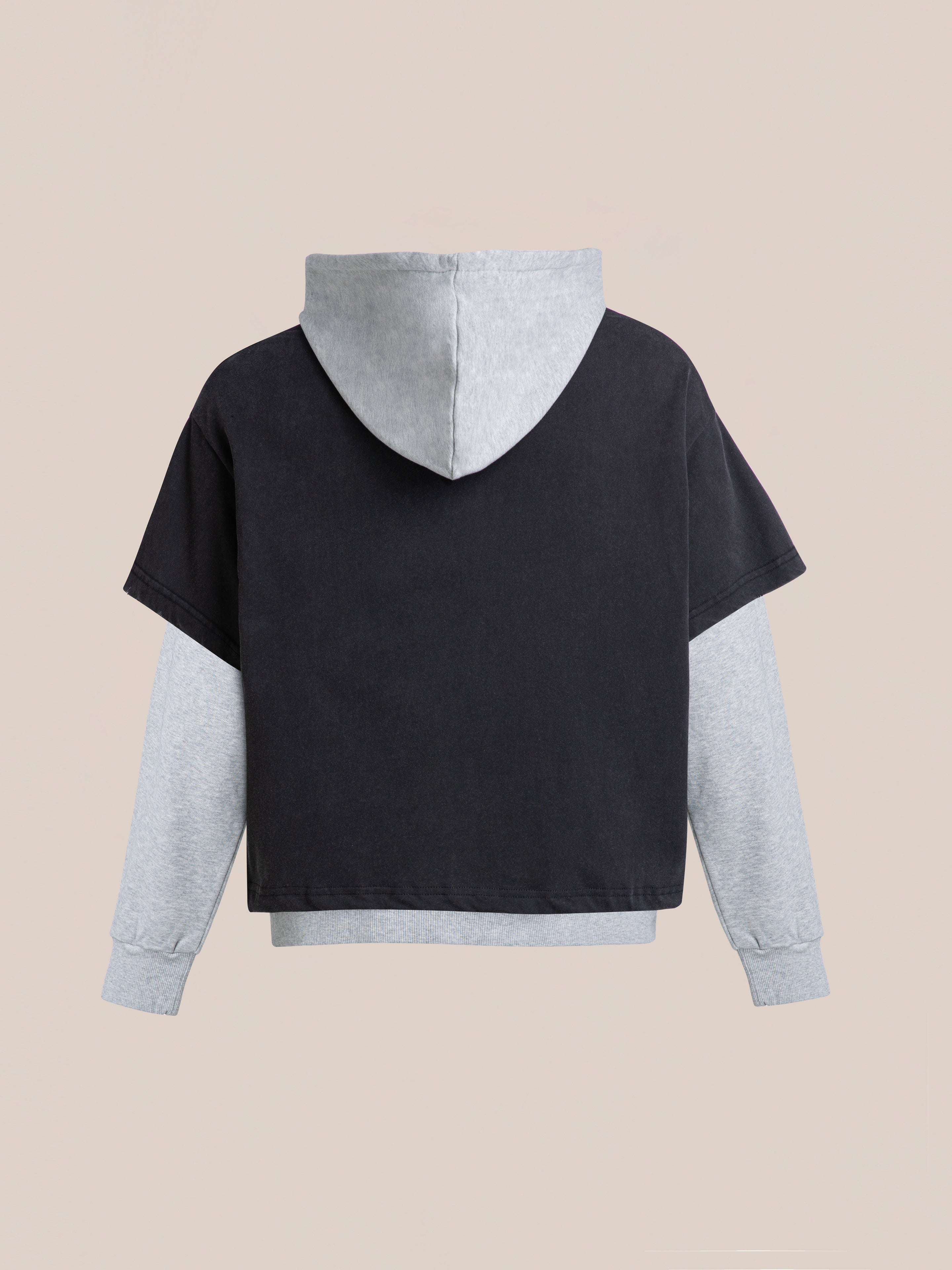 Introducing Found's Double Layer Hoodie, made from soft French terry cotton with a black short-sleeve design layered over gray long sleeves for a vintage look set against a subtle beige background.