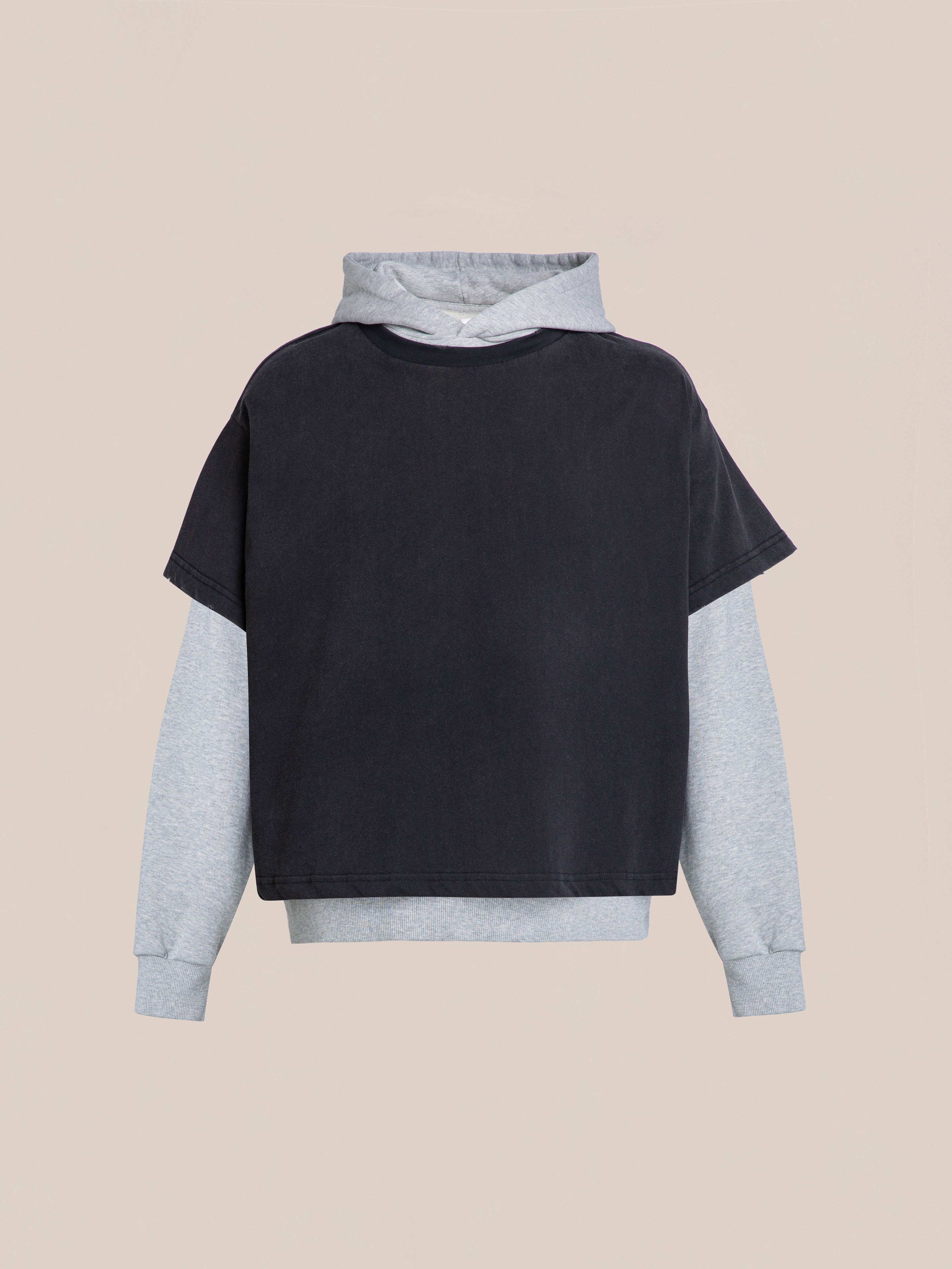 Introducing Found's Double Layer Hoodie, designed with a vintage aesthetic featuring a short-sleeved black top over a long-sleeved gray hoodie. Crafted from soft French terry cotton, it offers the perfect blend of comfort and timeless style.