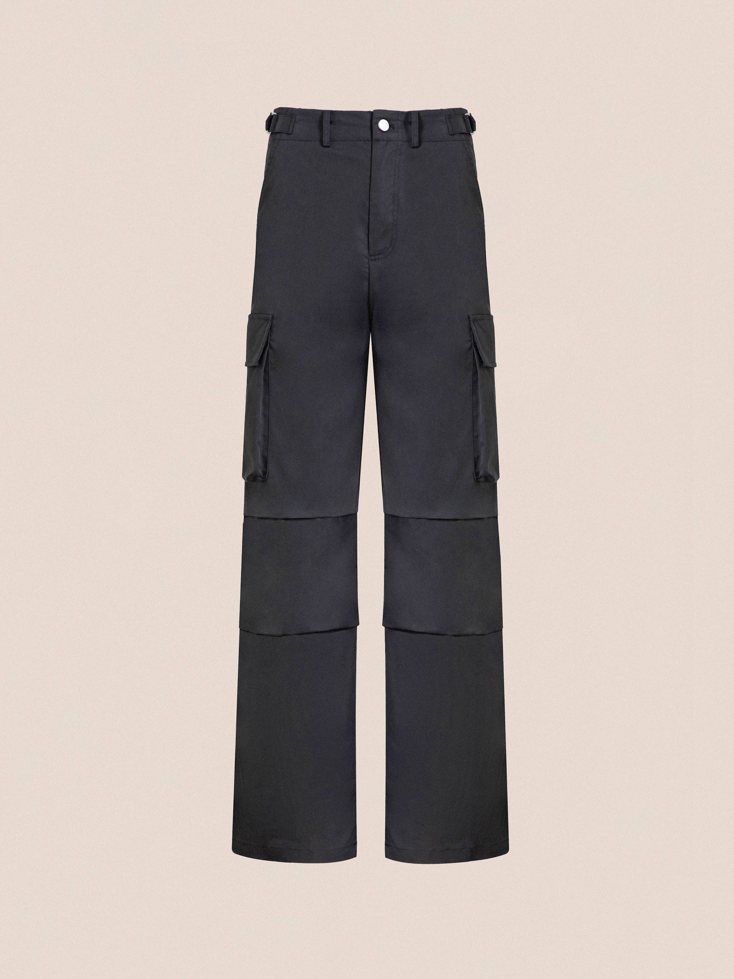 Black Found Elbas Cargo Pants with multiple pockets and a front button, displayed against a neutral beige background.