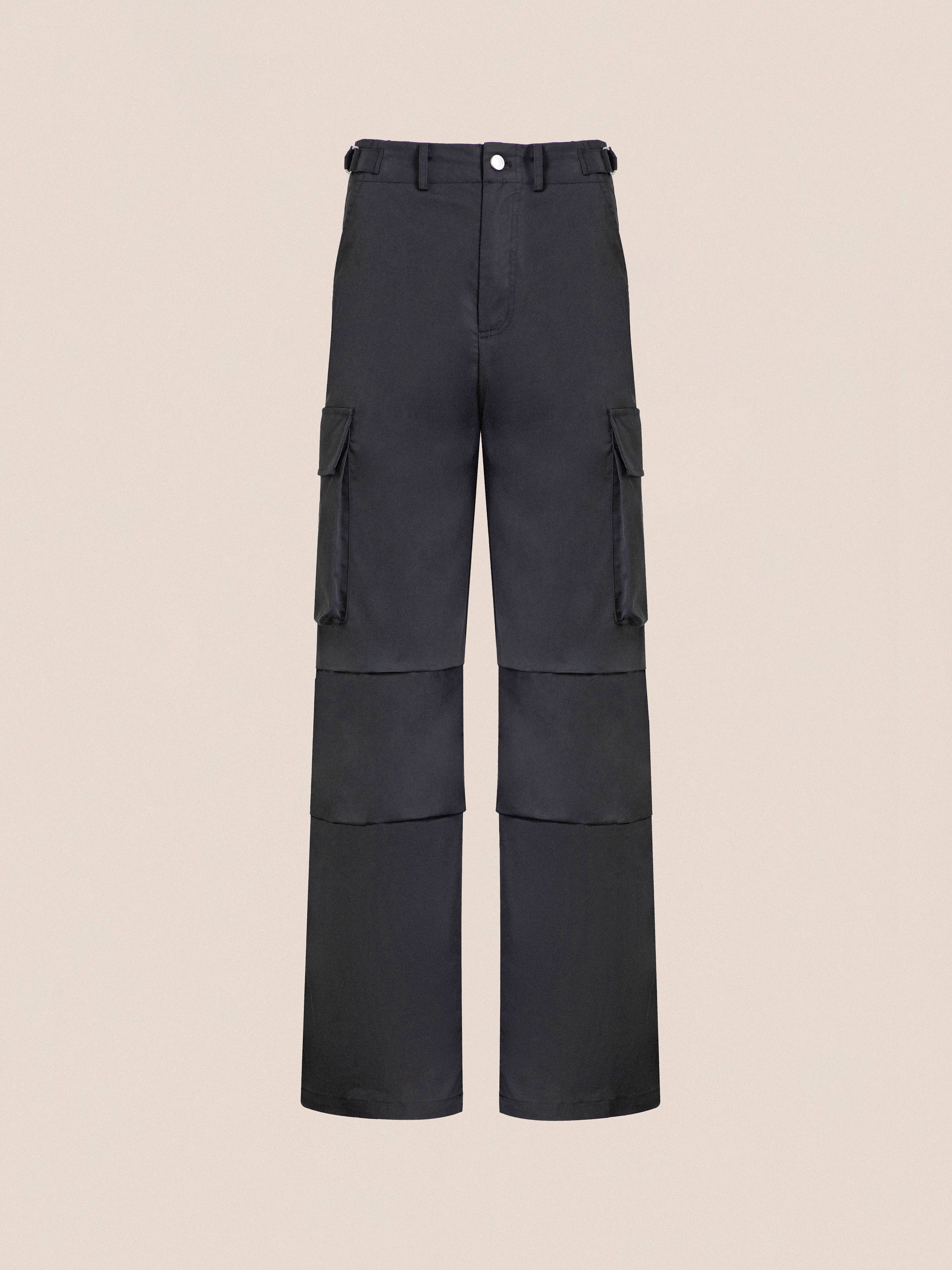 Black Found Elbas Cargo Pants with multiple pockets and a front button, displayed against a neutral beige background.