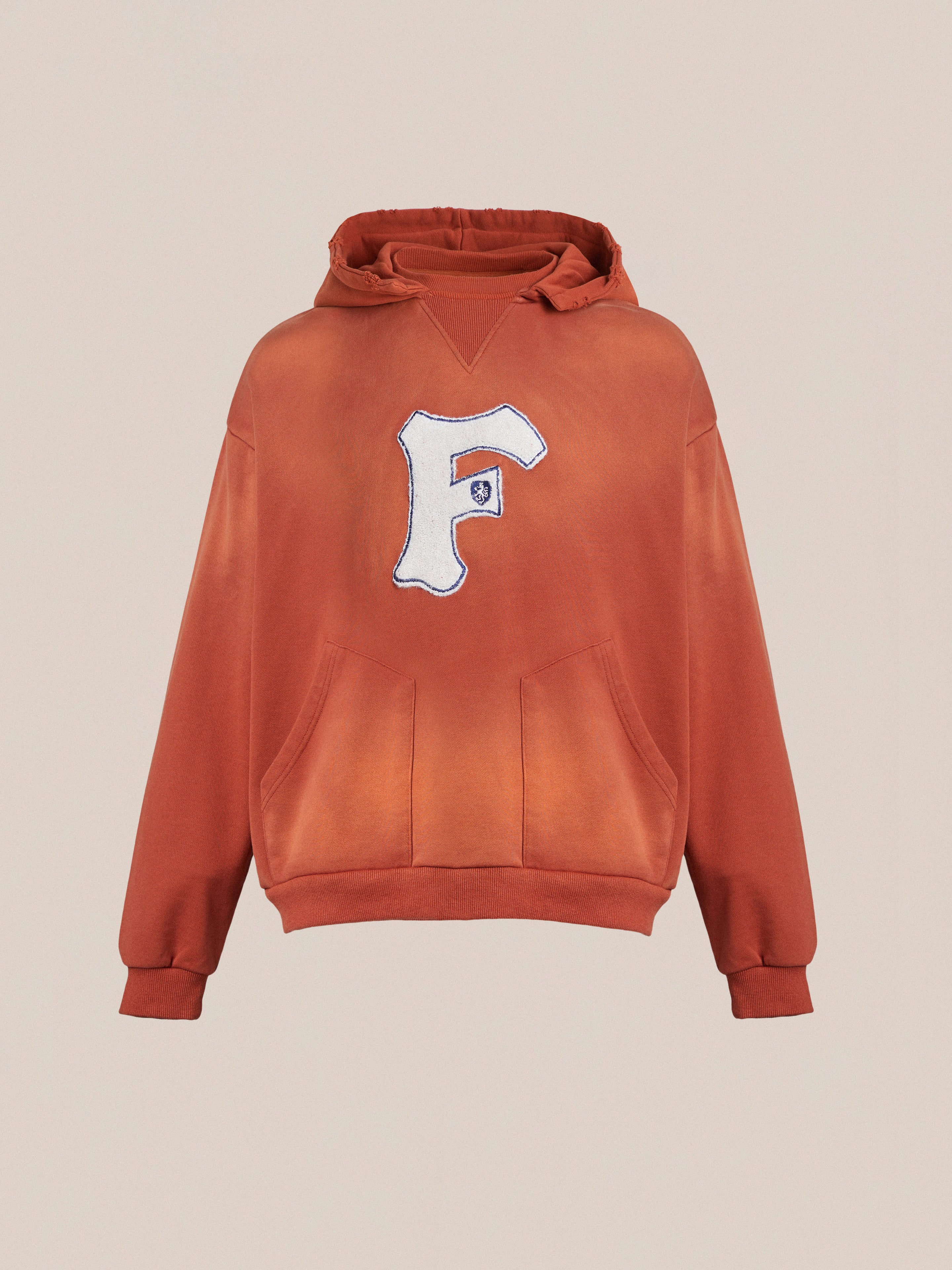 An enzyme washed cotton Faded "F" Hoodie in orange by Found, evoking vintage nostalgia.