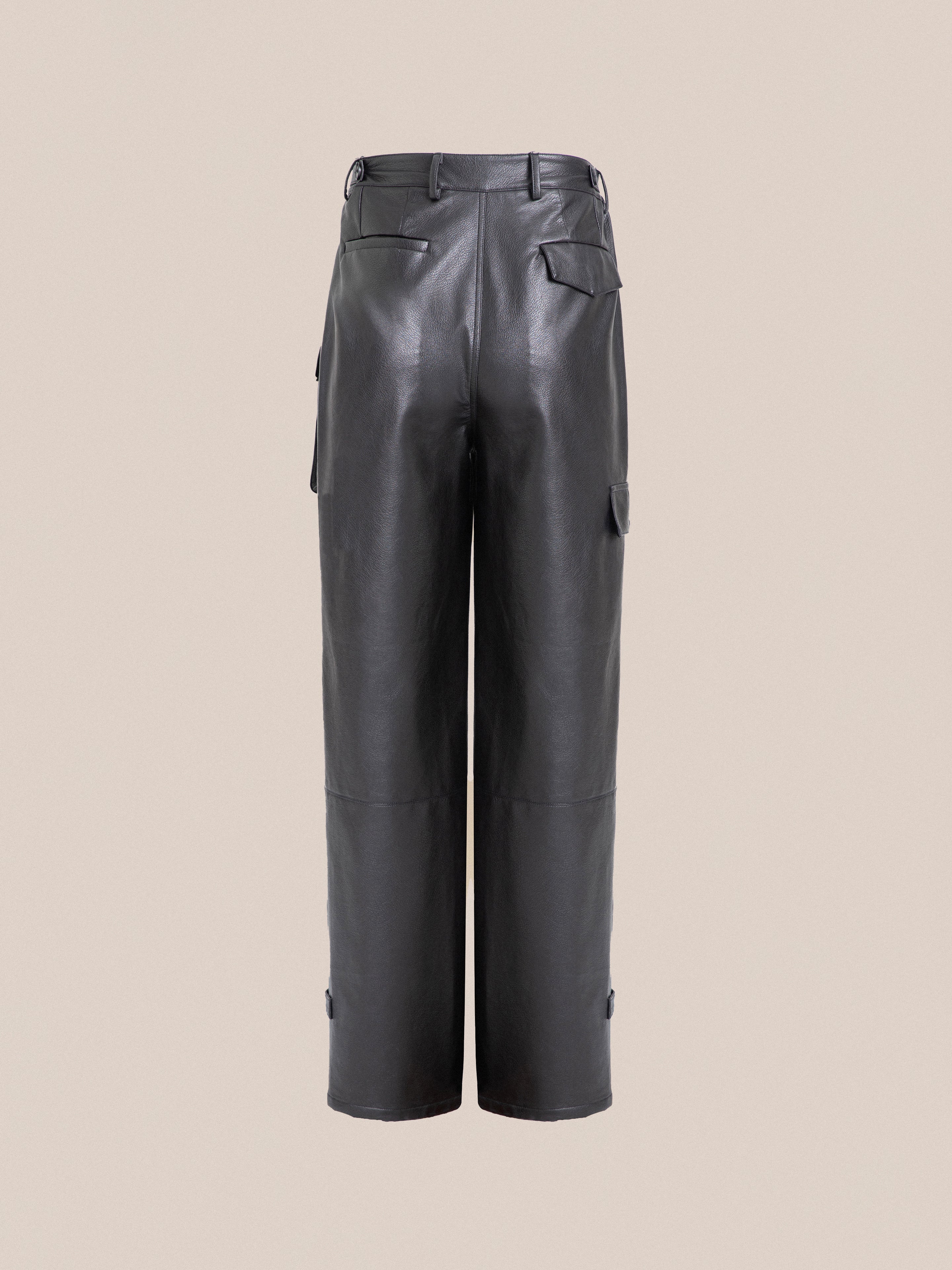 A pair of black Found faux leather cargo pants with cargo pockets.