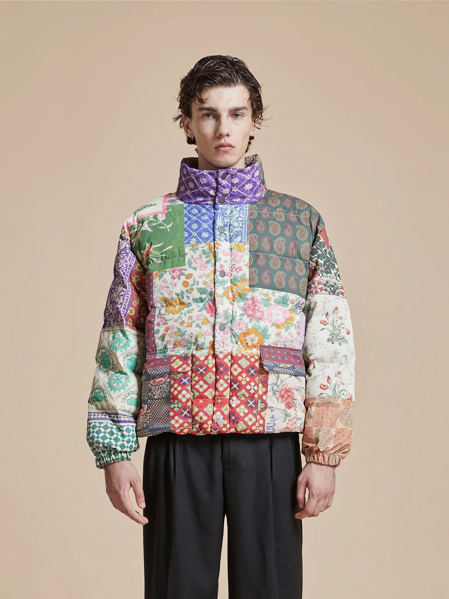 A man wearing a Found Gardenia Tapestry Puffer Jacket.