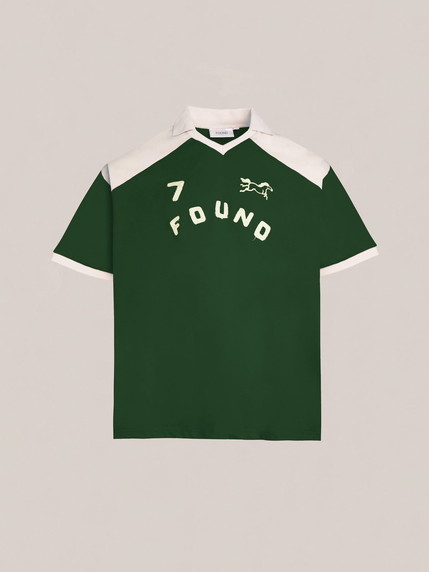 The Goji Green Jersey from FOUND exudes a vintage athletic uniform style, featuring a white collar and contrasting yoke. It is adorned with an embroidered number 7, the word 