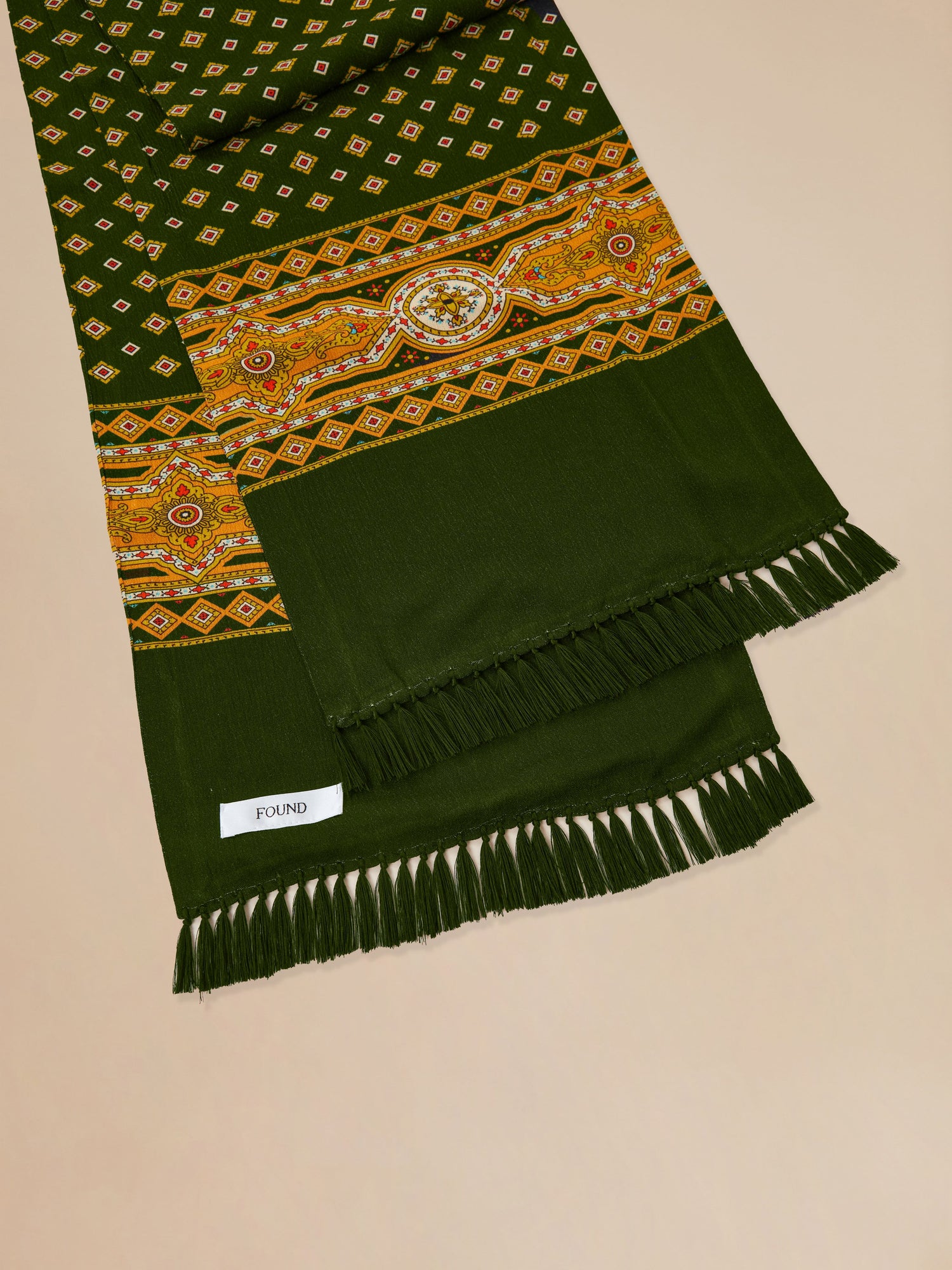 A Greener Pastures scarf with tassels made by Found.