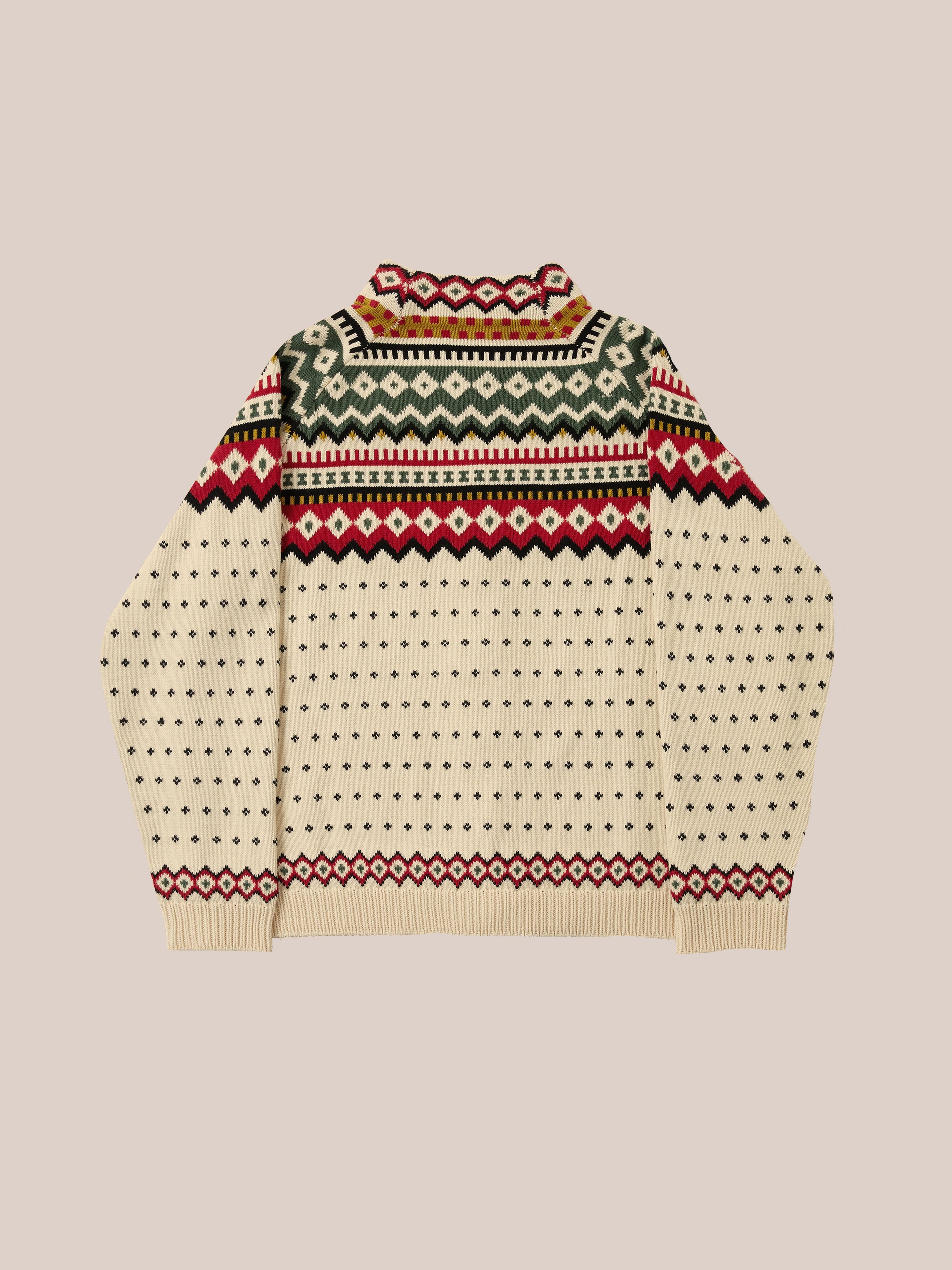 The Harwan Isles Sweater by Found is a cream-colored knitted piece showcasing a multicolored geometric pattern inspired by iconic Scottish Fair Isle designs, incorporating green, red, and black.