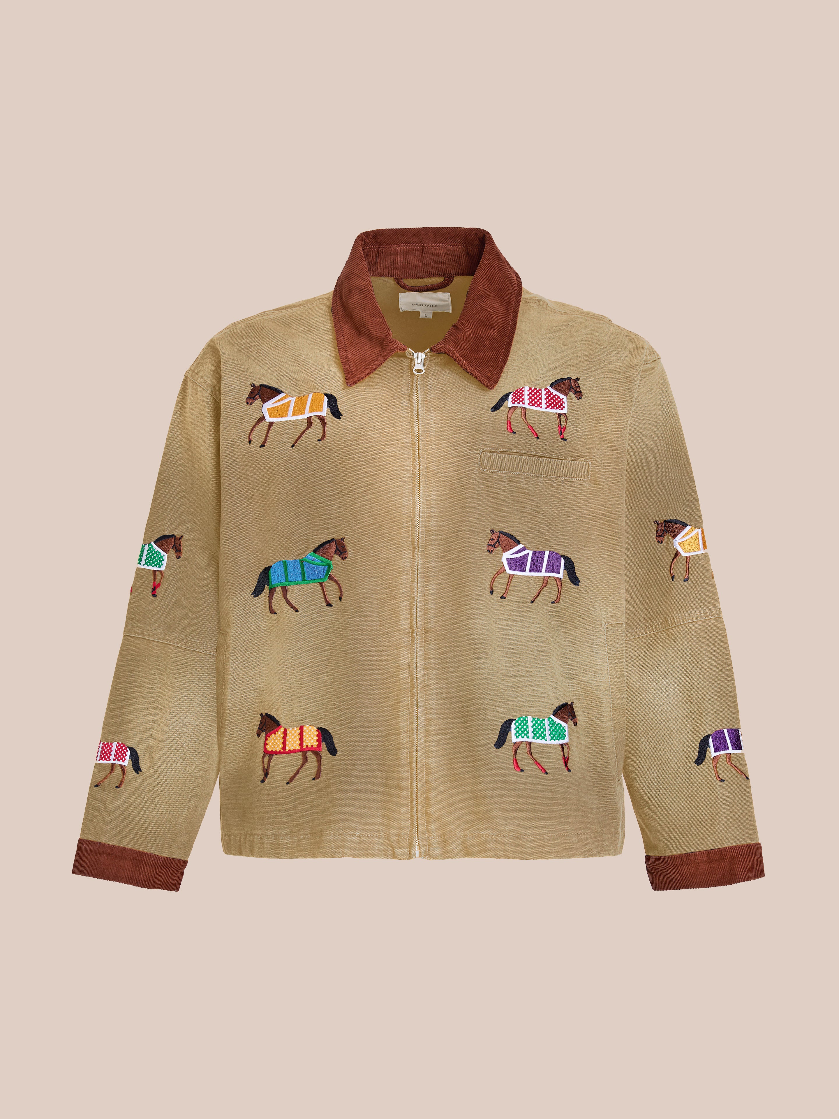 The Found Lariat Horse Embroidered Work Jacket is a tan equestrian jacket with a brown collar and colorful embroidered horses, shown on a plain light beige background.