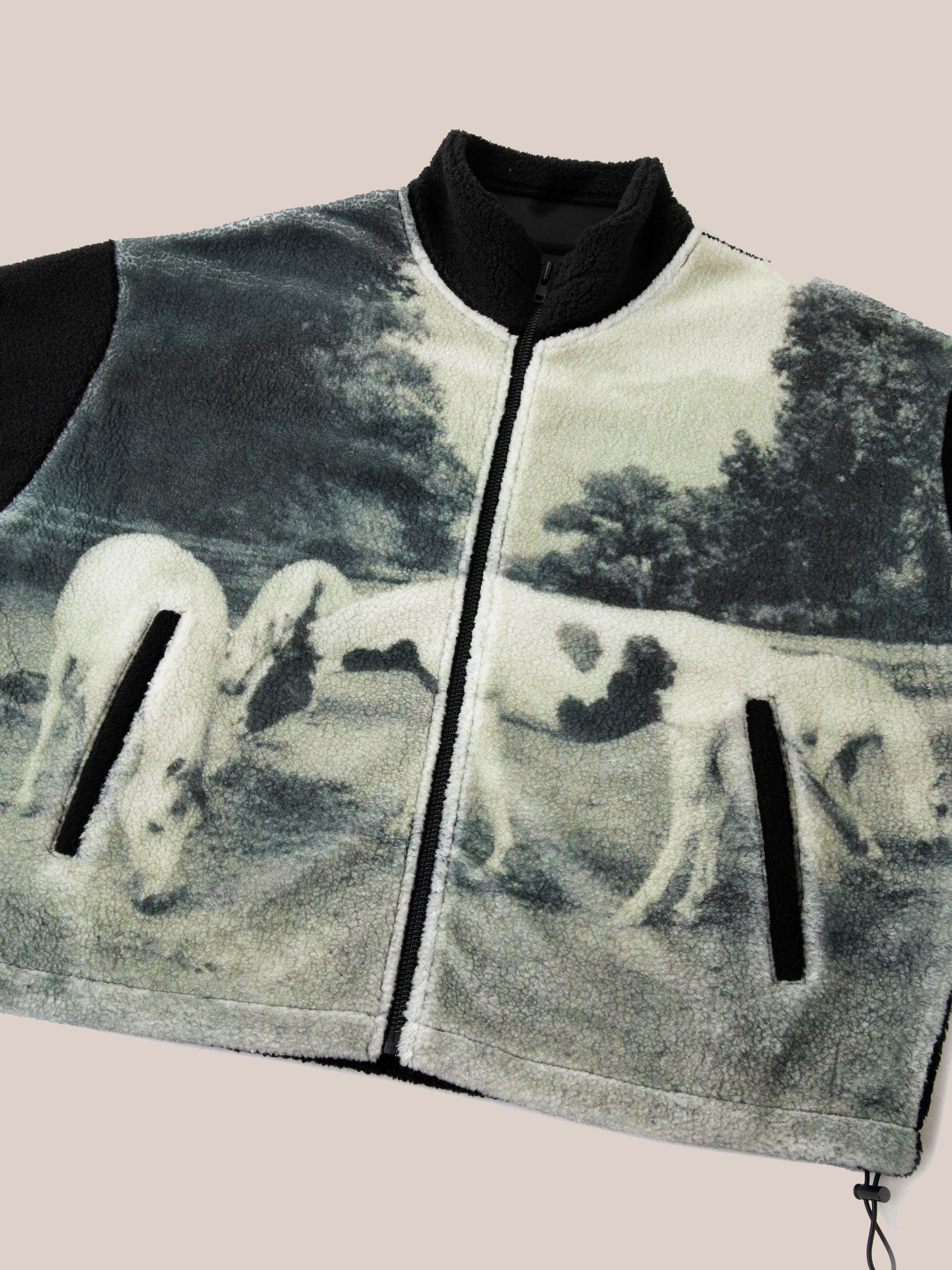 The FOUND Horses Zip-Up Sherpa Jacket, made from cozy sherpa fabric, features a pastoral scene with grazing horses in an impressive sublimation print. It rests flat against a neutral background, providing both warmth and style.