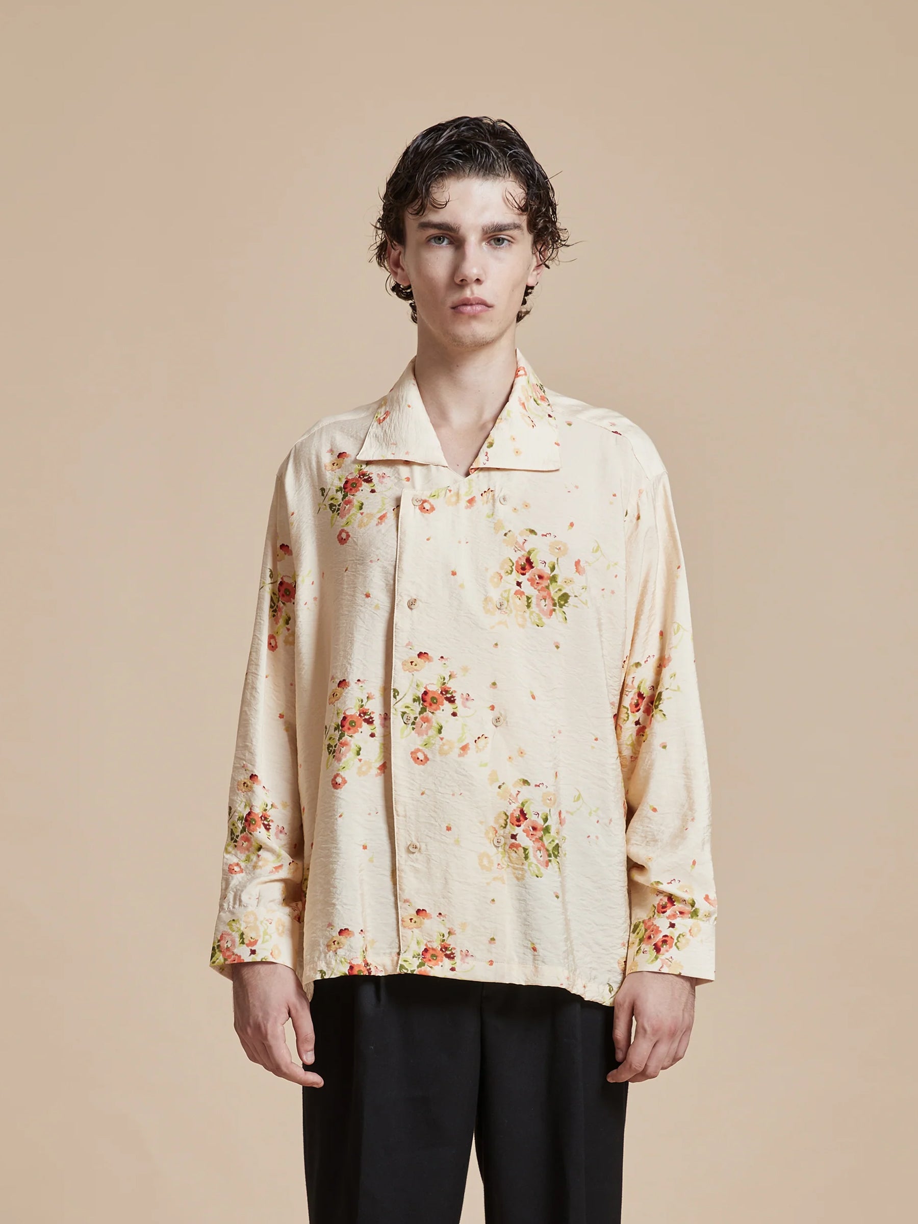 The model is wearing a Found Kanhati Garden Long Sleeve Camp Shirt with beige Phulkari motifs.