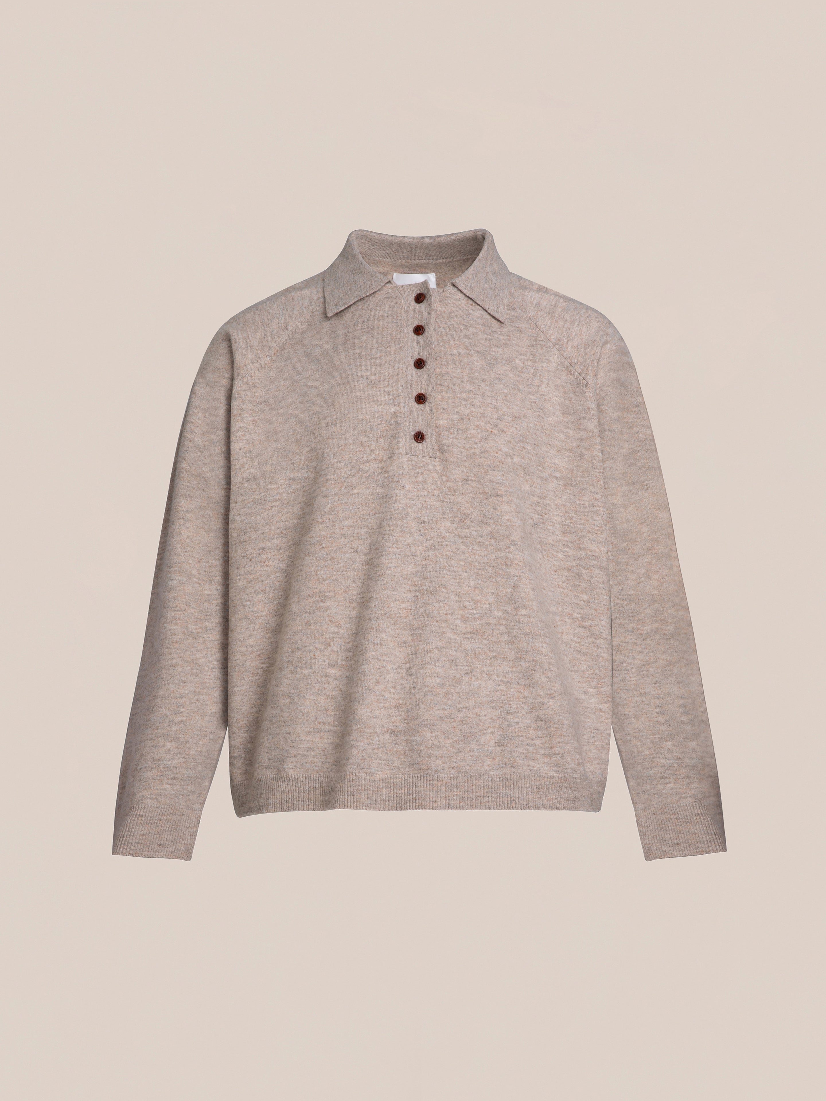 The Hay Collared Knit Henley by FOUND is a beige long-sleeve sweater featuring wooden buttons and a collar, displayed against a plain background.